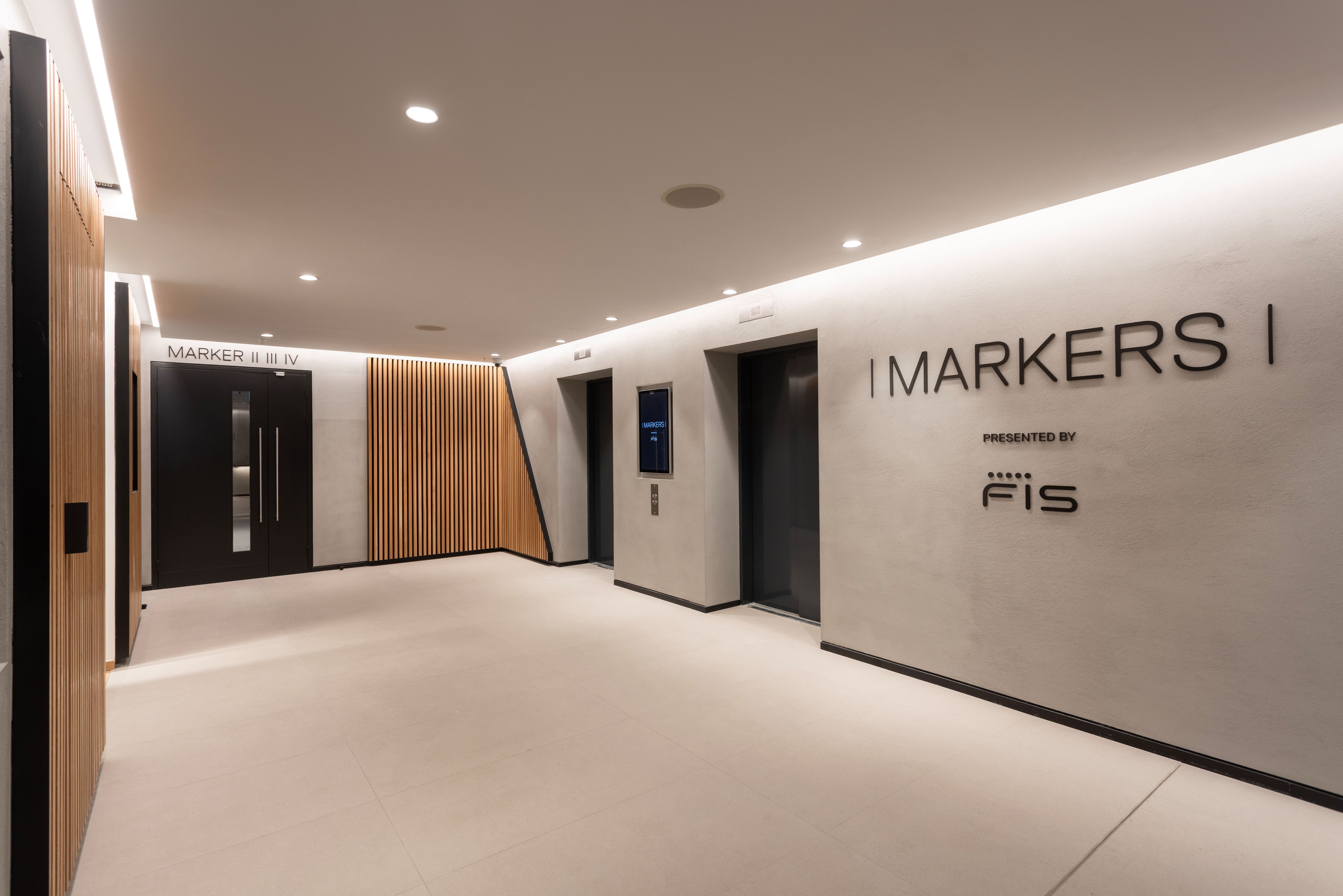 Sleek modern entrance with wayfinding signage at FIS event in Fulham Pier.