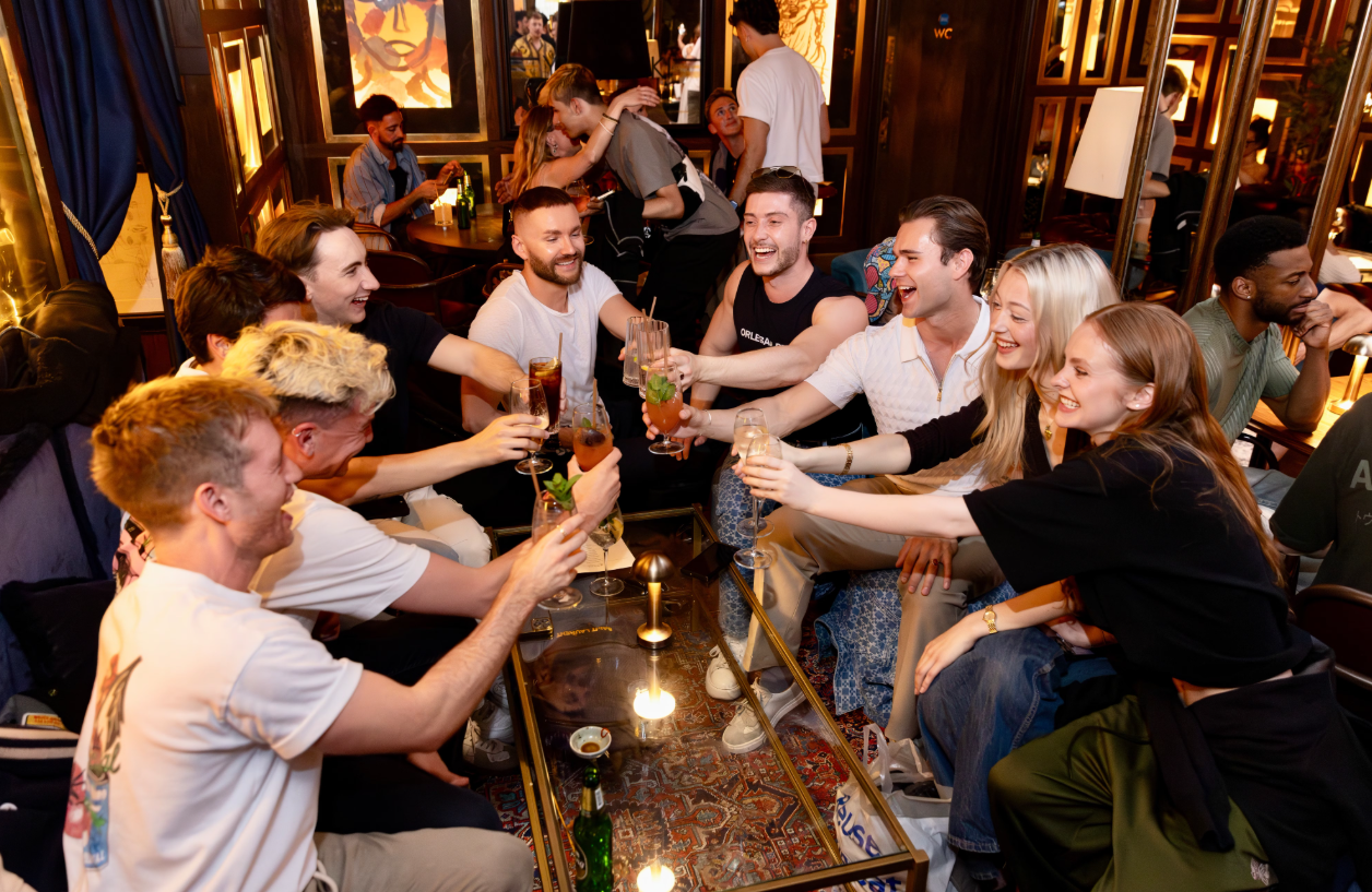 Lively social event at Backstage Soho with vibrant decor and engaged attendees.