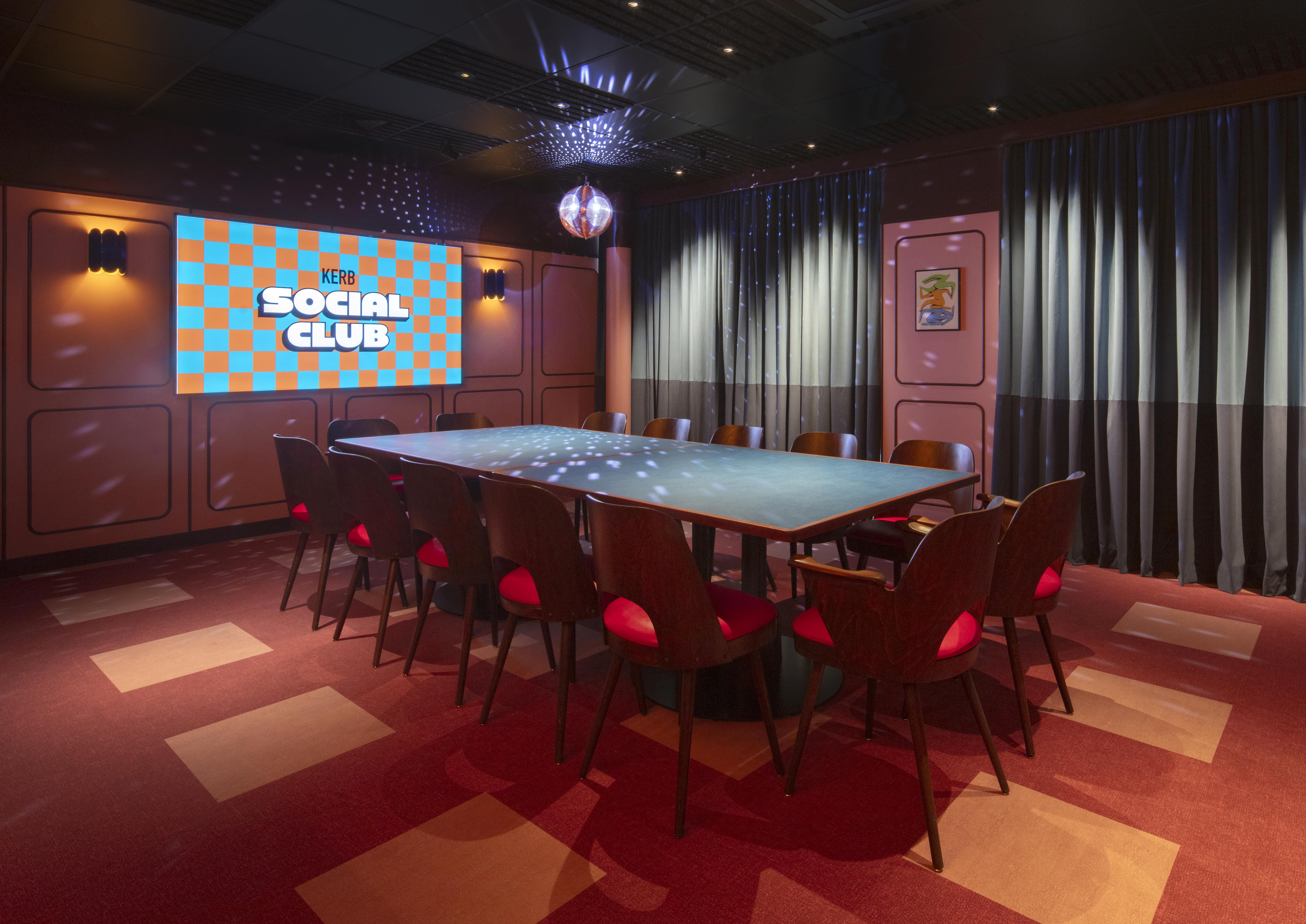 Stylish meeting room with large screen at KERB Social Club for creative events.
