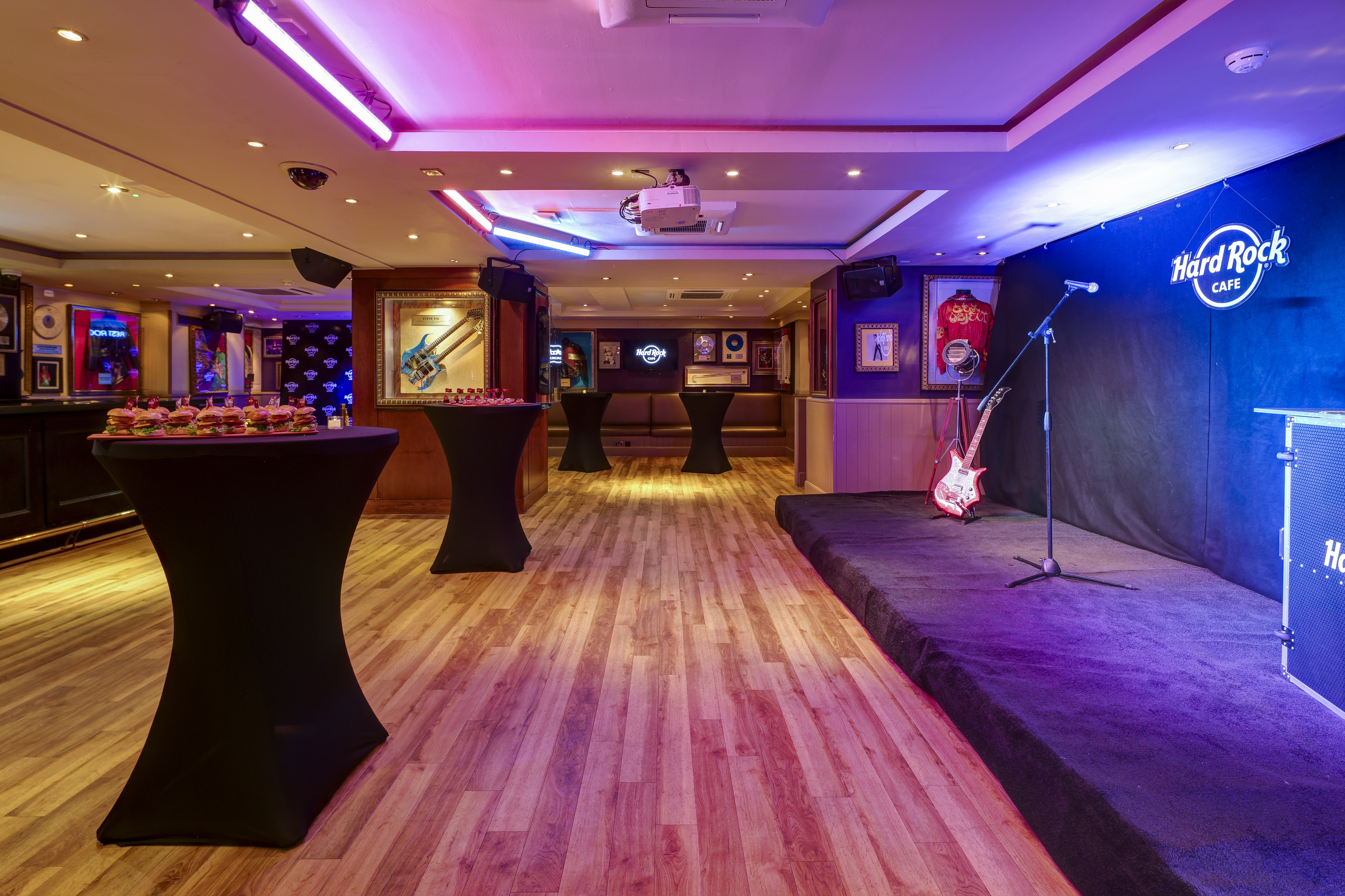 Networking event at Hard Rock Cafe London with vibrant stage and modern decor.