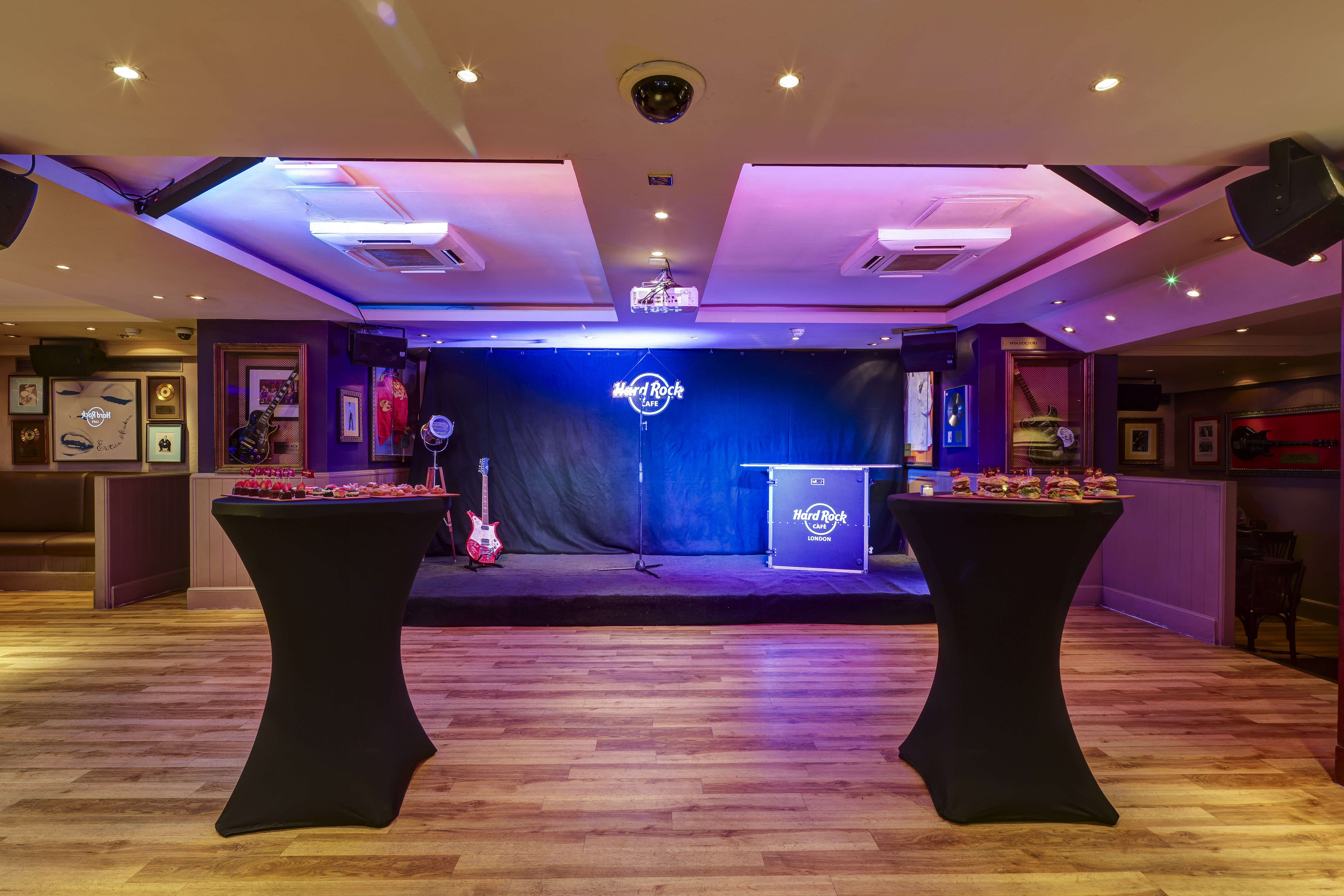 Networking event space at Hard Rock Cafe London with stage and mood lighting.