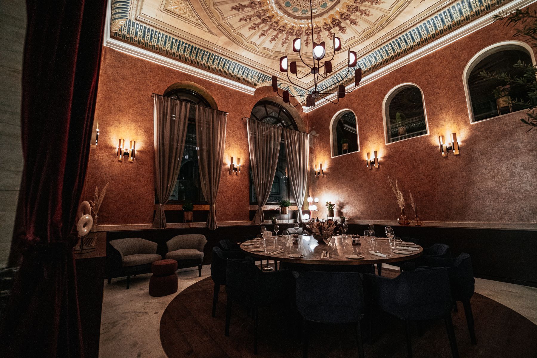 Elegant meeting space with plush seating and ornate decor for corporate events.