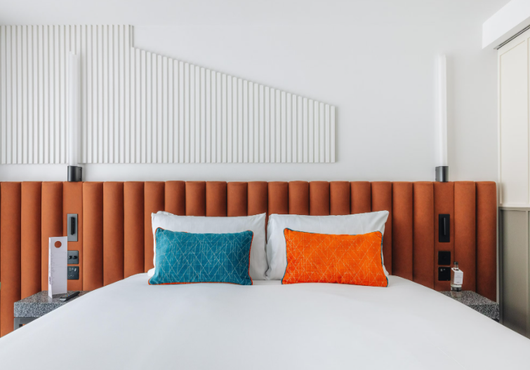 Modern Hotel Indigo London Clerkenwell bedroom with sleek design for corporate events and conferences.