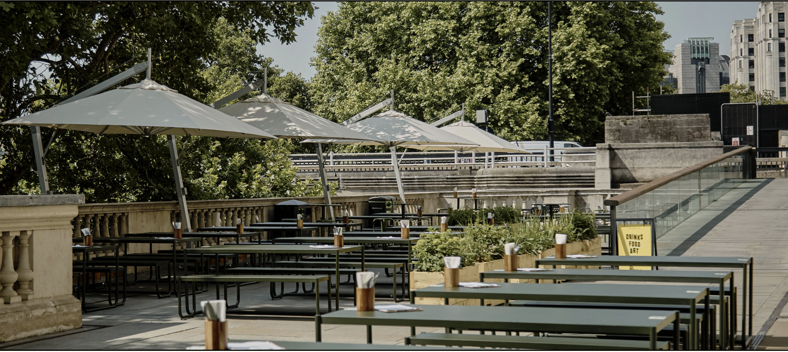 Outdoor event space with green benches for summer parties and private hire gatherings.