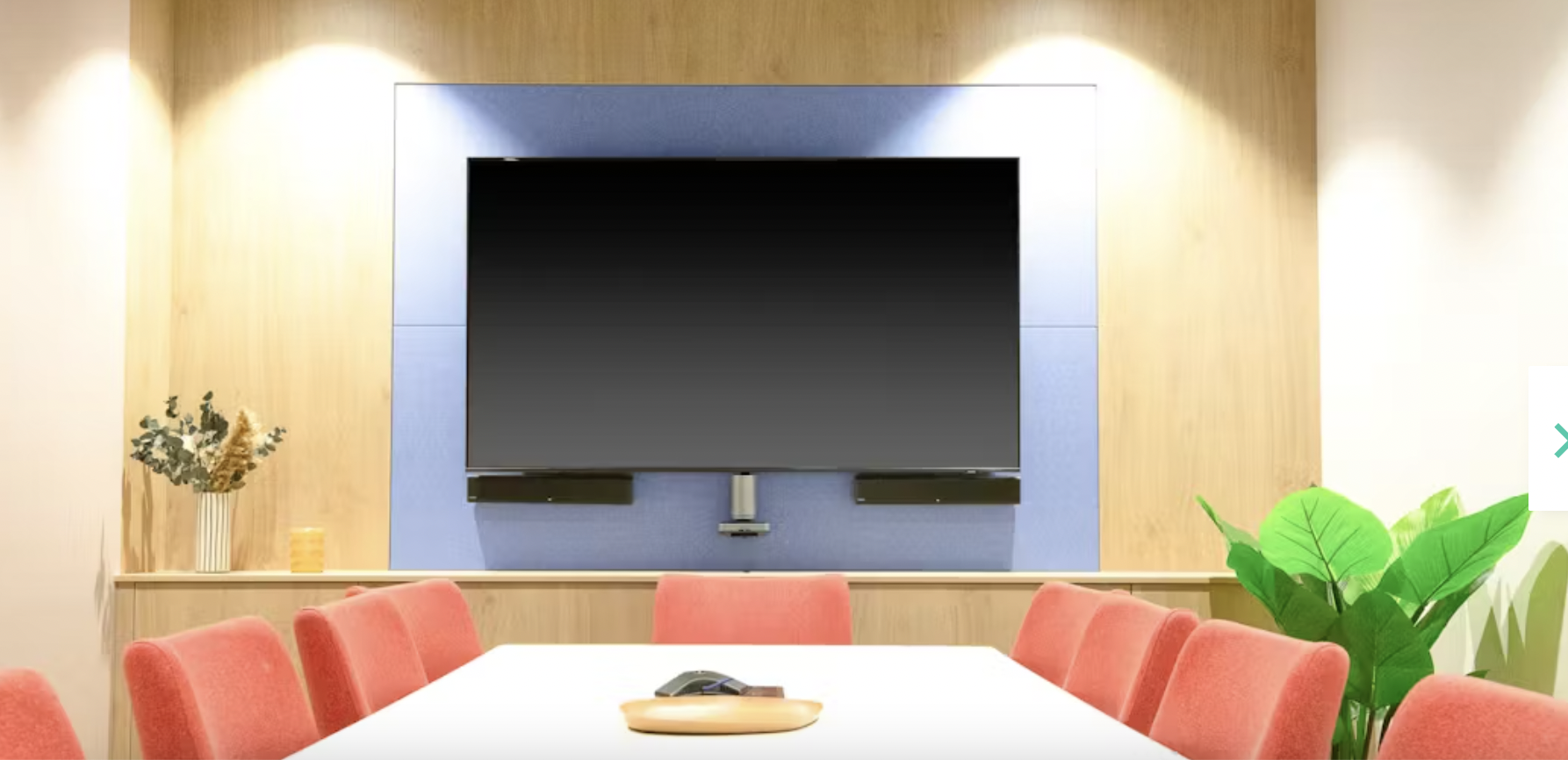 Modern meeting room in Runway East Birmingham with red chairs, ideal for events and presentations.