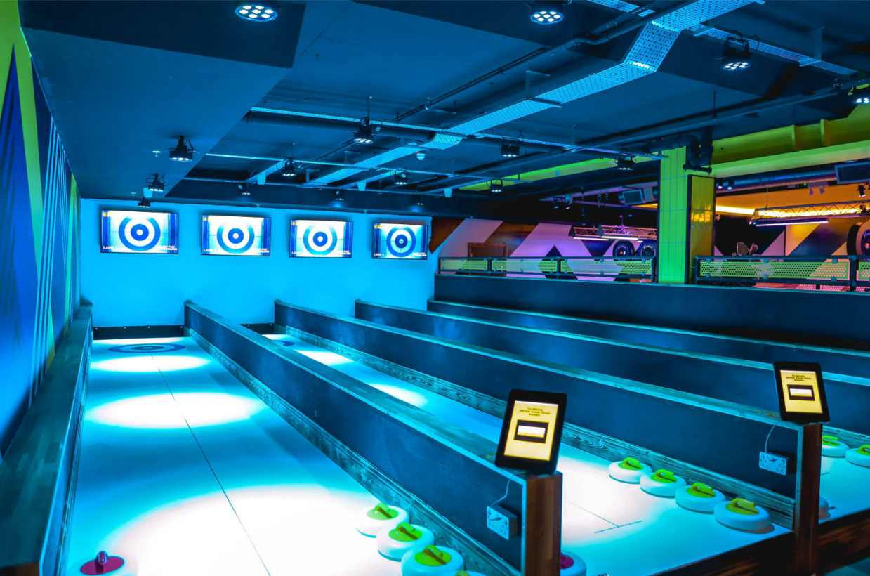 Modern event space at King Pins Bristol with glowing bowling lanes, perfect for gatherings.
