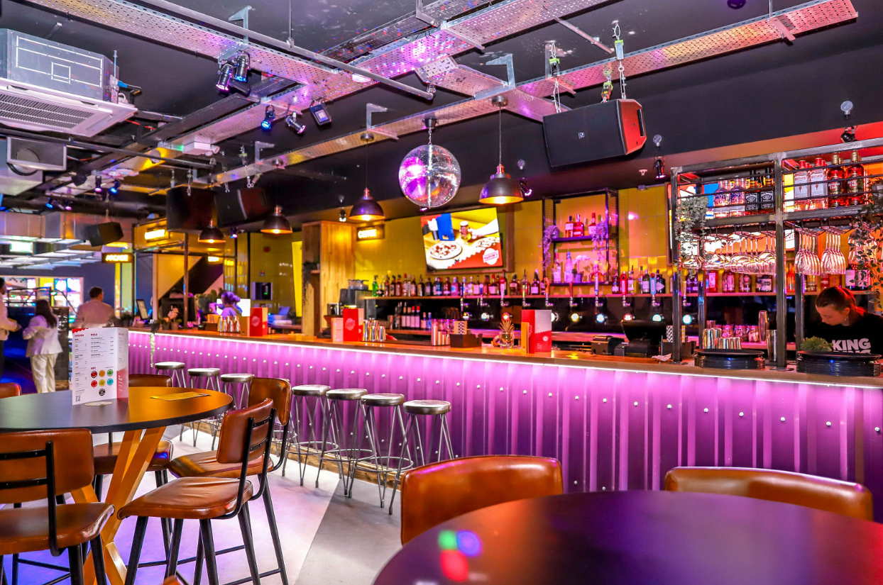 Modern bar venue in King Pins, Bristol for networking and parties with colorful lighting.