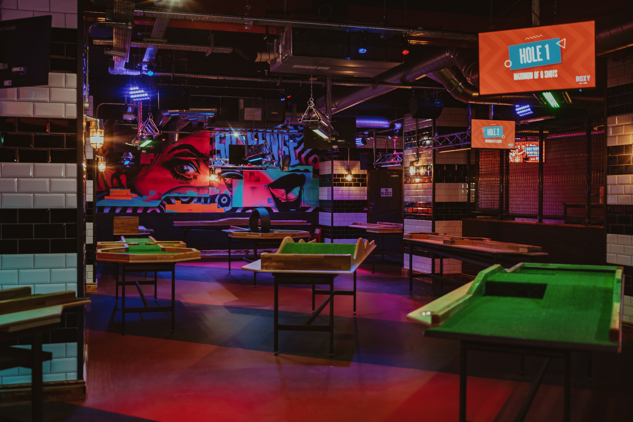 Vibrant Roxy Ball Room venue hire with illuminated signage for team-building events.