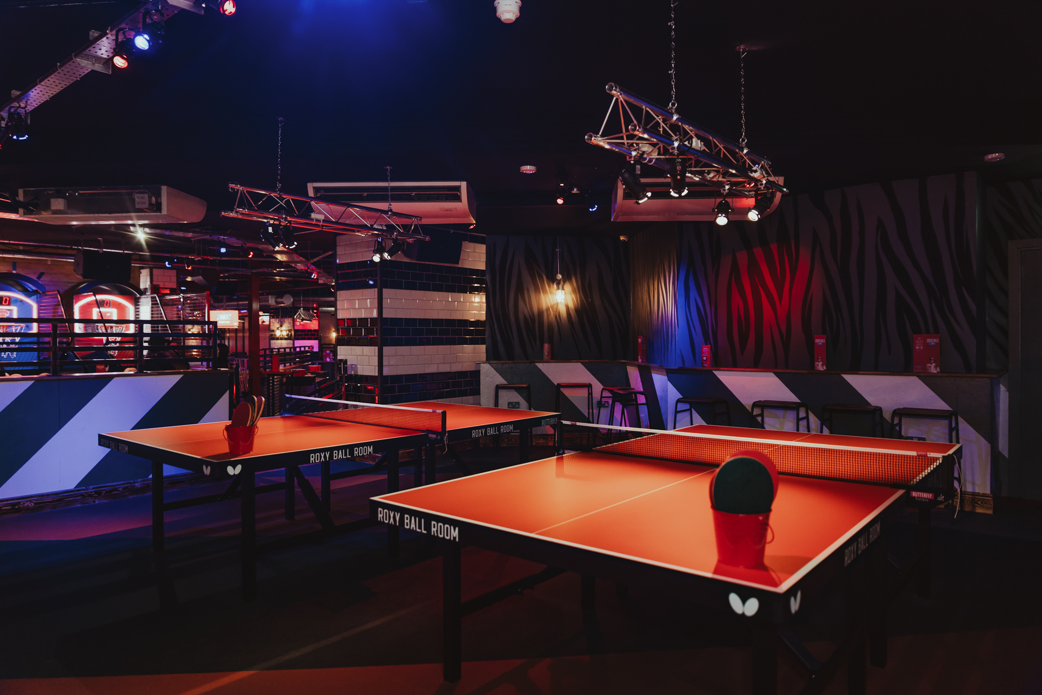 Vibrant Roxy Ball Room in Birmingham with ping pong tables for team-building events.