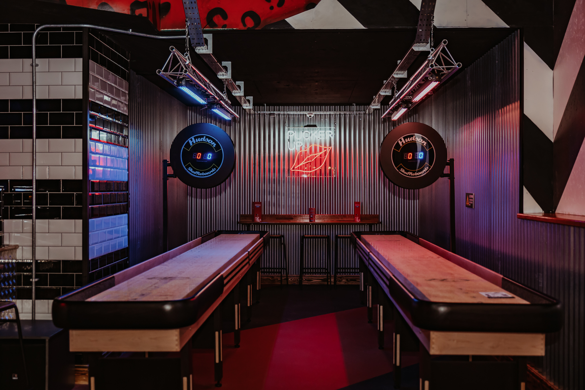 Trendy event space with shuffleboard tables in Birmingham for networking and team-building.
