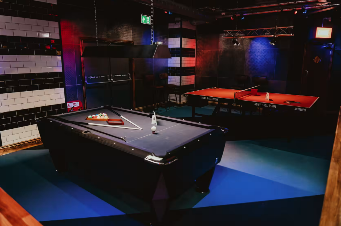 Vibrant Roxy Ball Room with pool tables for team-building and networking events.