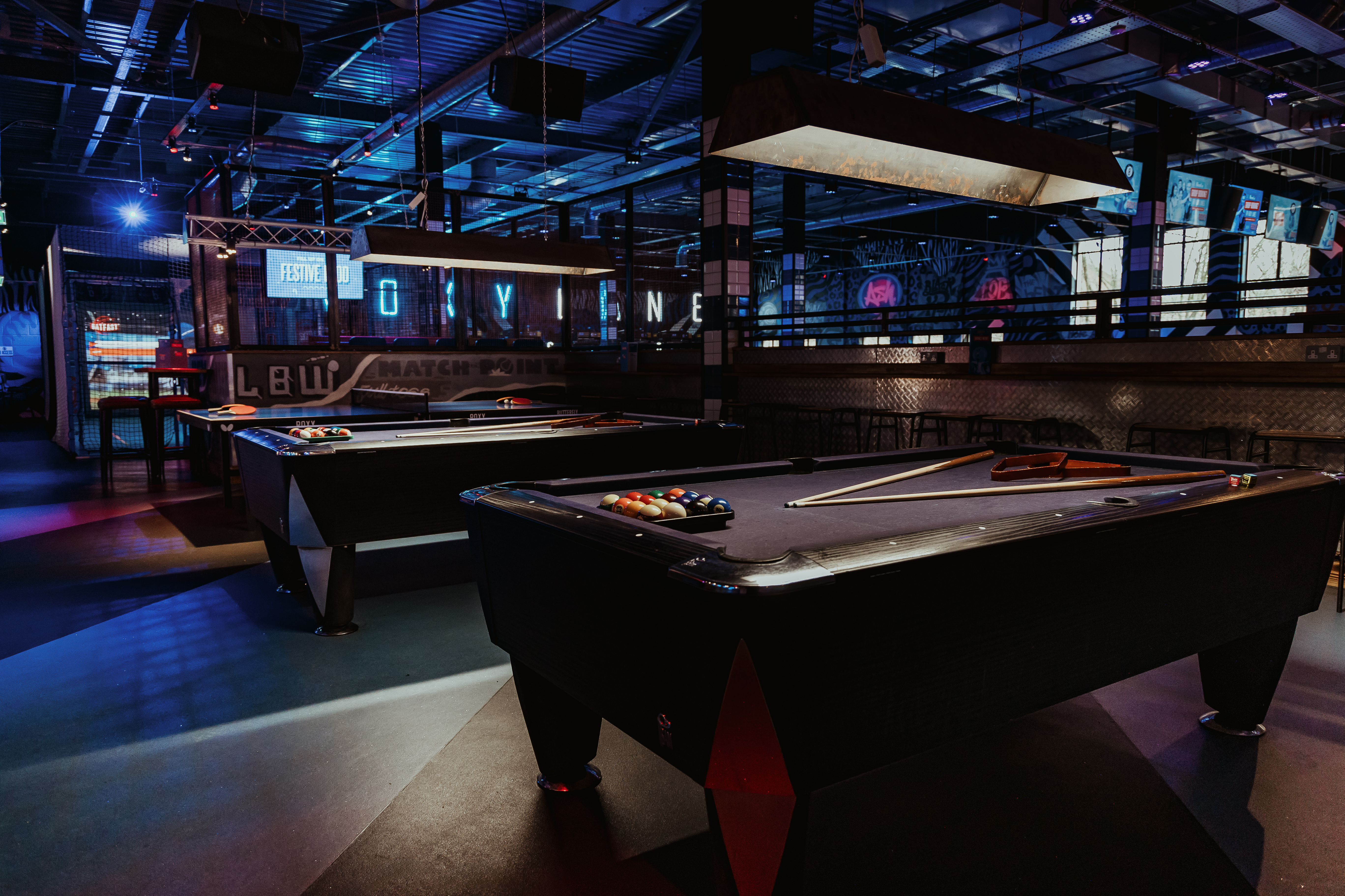 "Vibrant Roxy Lanes venue with pool tables for networking and team-building events."