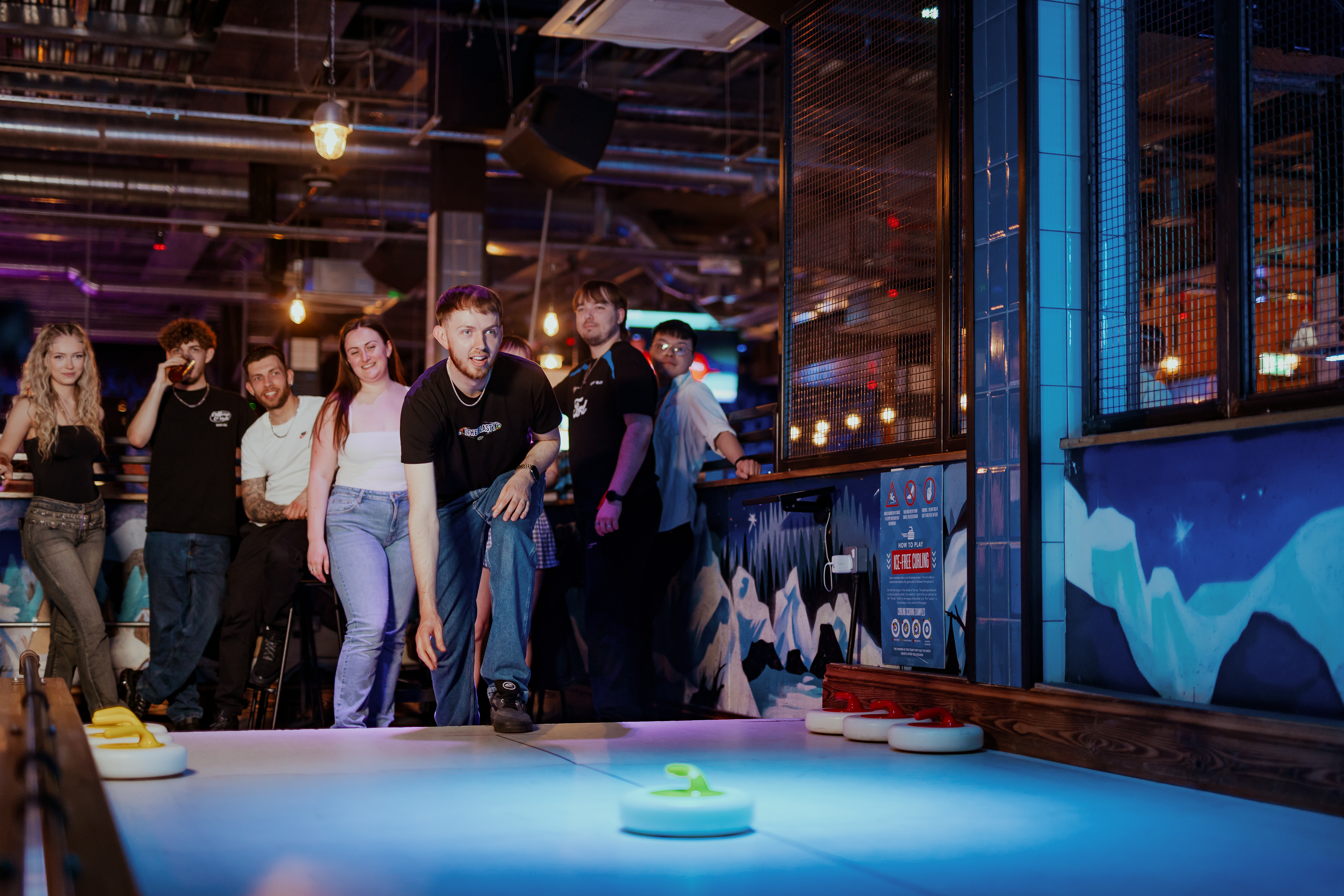 Lively team-building event at The Lodge, Bristol with vibrant lighting and fun games.