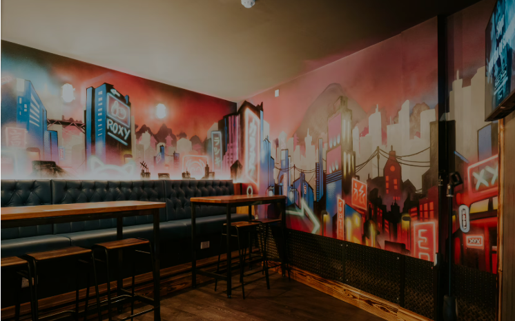 Karaoke room at Roxy Lanes Bristol with vibrant mural for events and team-building.