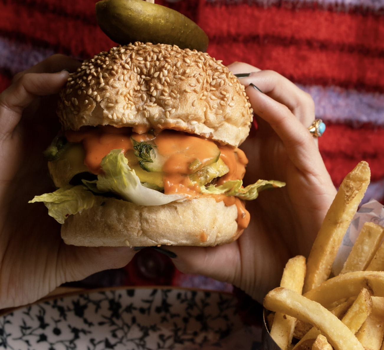 Delicious burger with vibrant toppings at Schenke Tavern event in Soho.