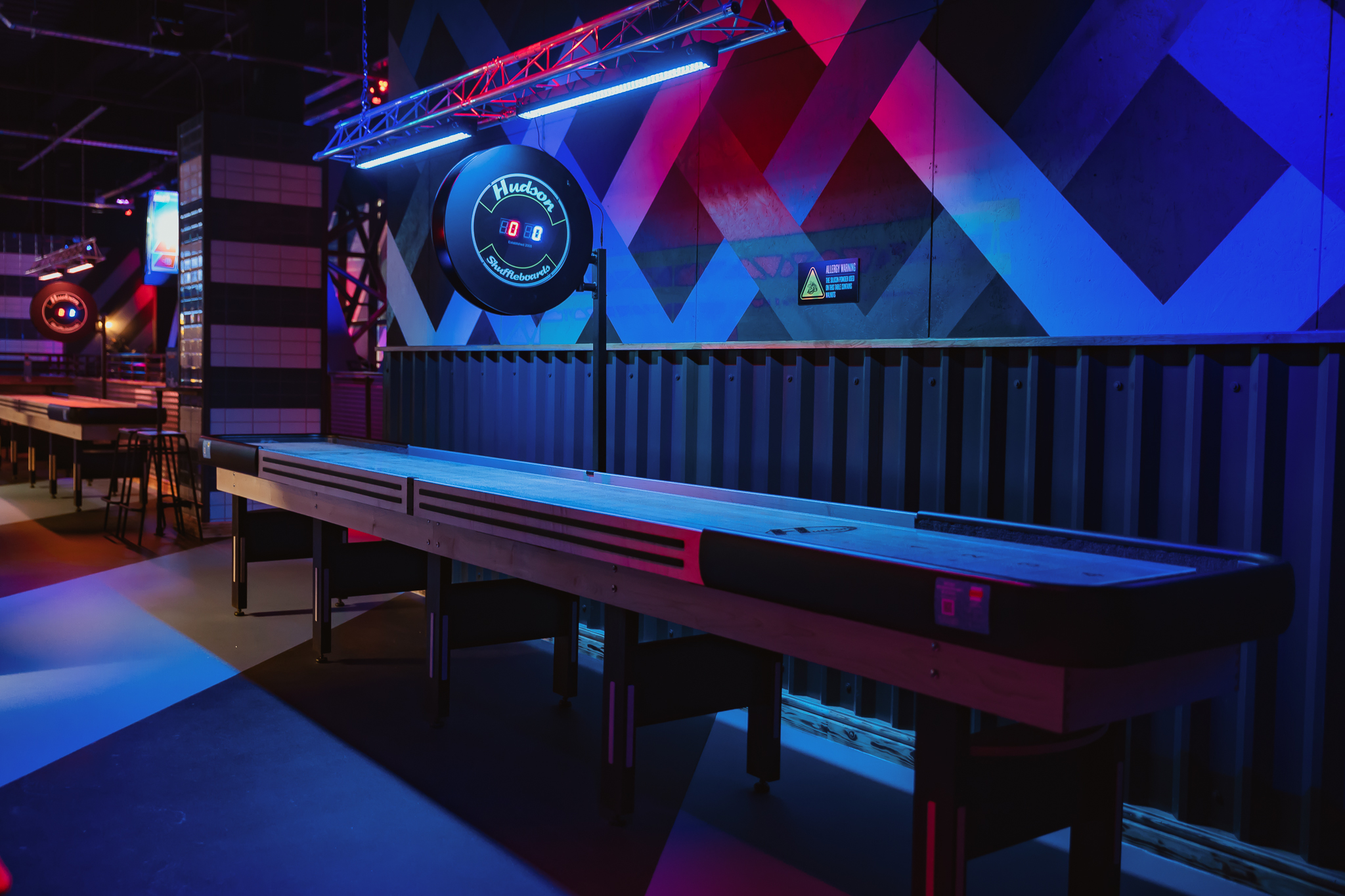 Vibrant shuffleboard area at The Gallery, Roxy Lanes Cardiff for team-building events