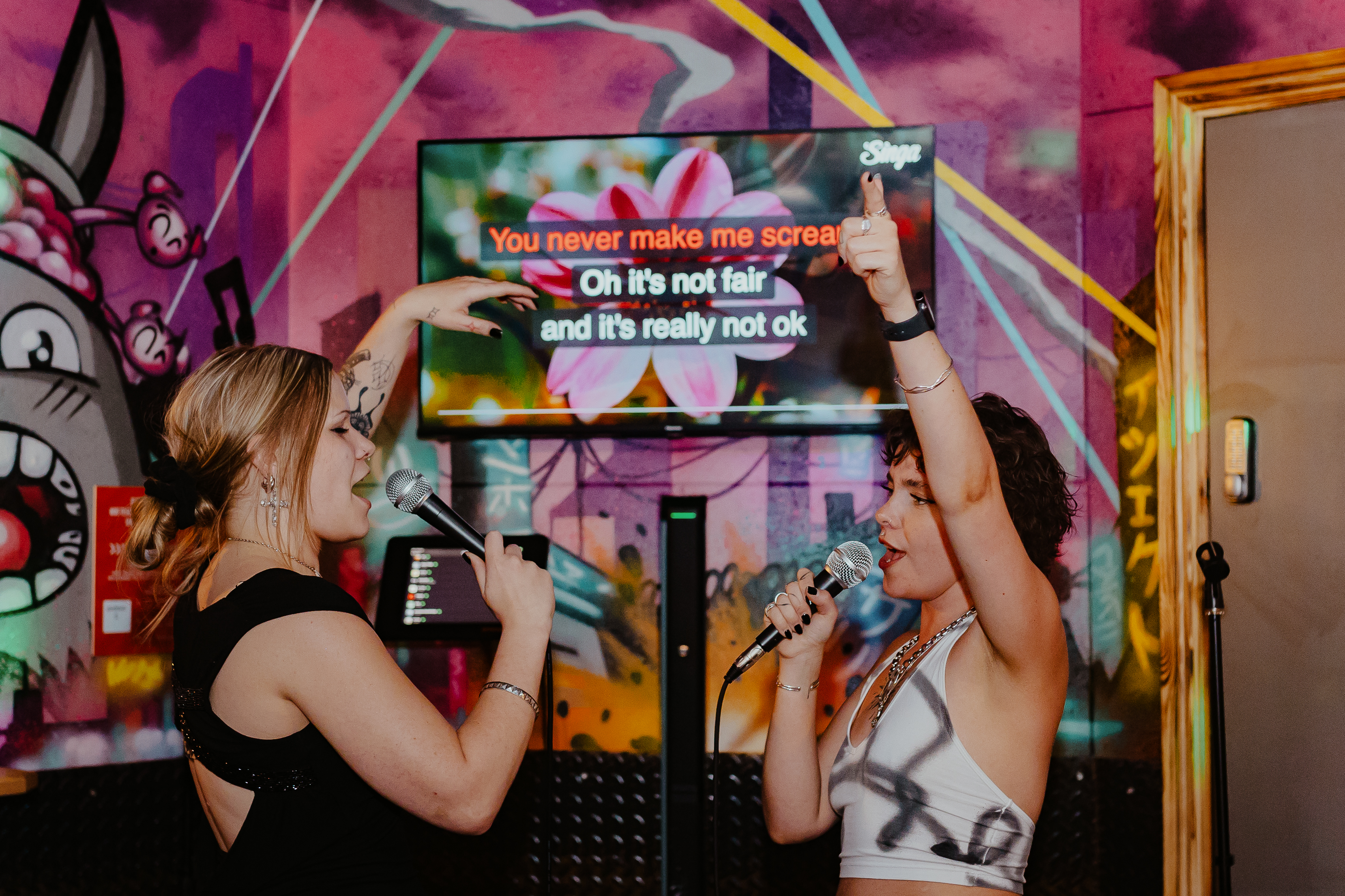 Karaoke room at Roxy Lanes, Cardiff; vibrant setting for team-building entertainment.