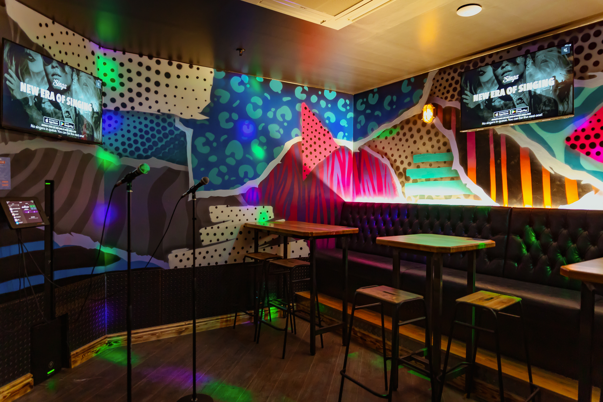 Vibrant karaoke room at Roxy Lanes, Cardiff, ideal for team-building events and celebrations.