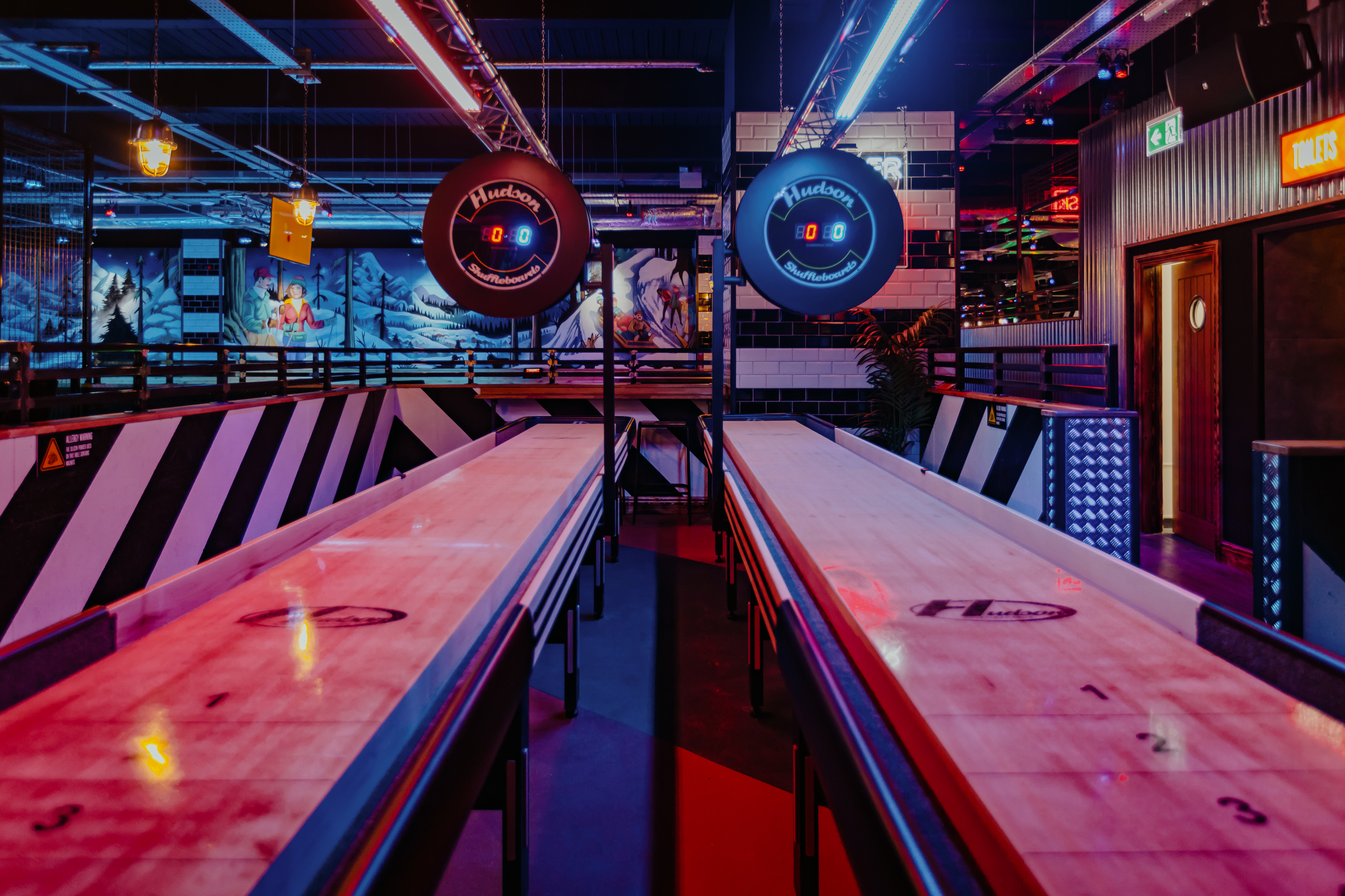 Vibrant Roxy Ball Room venue with illuminated shuffleboard for corporate events in Leicester.