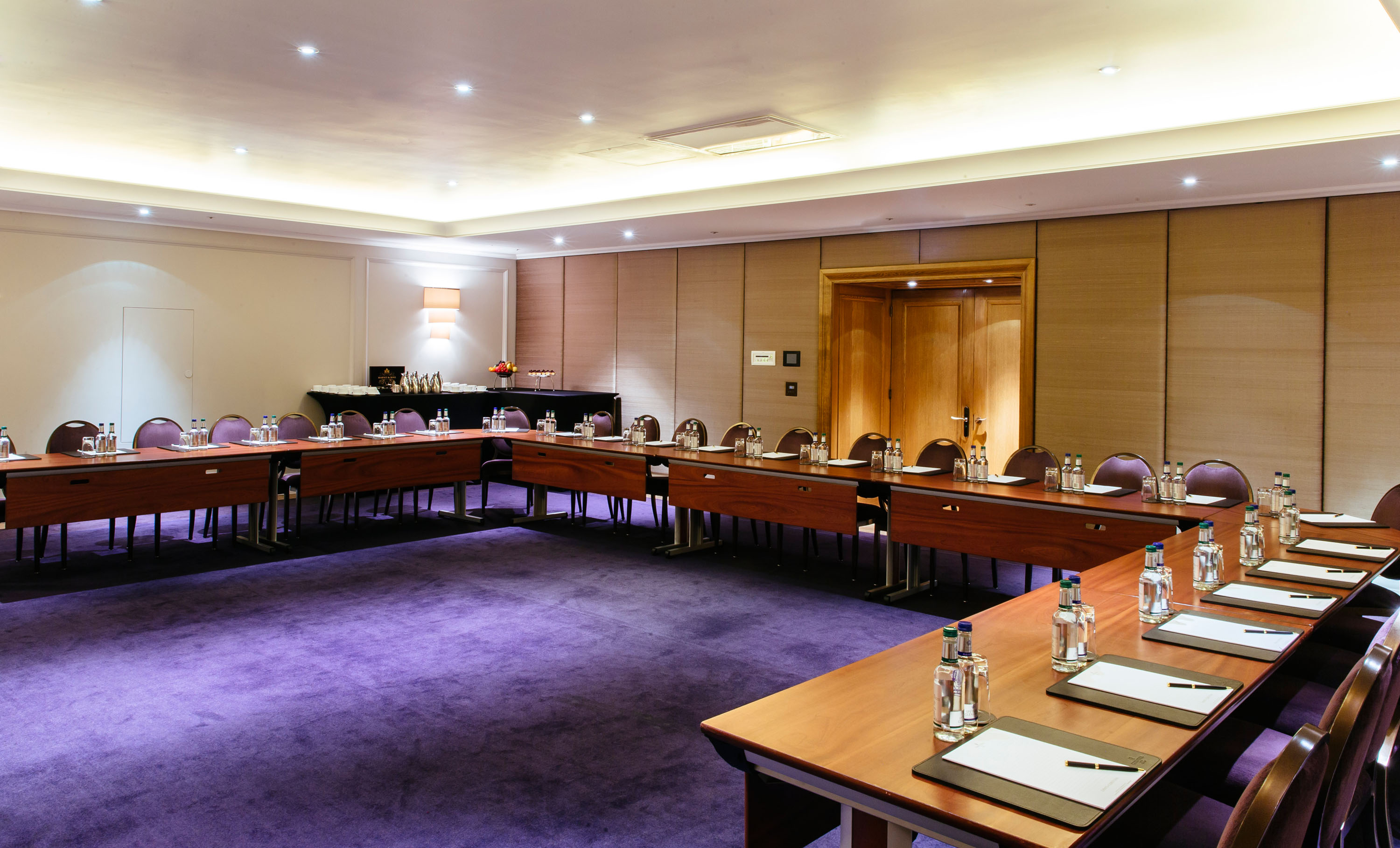 Nelson Room in Corinthia London, U-shaped layout for meetings, elegant decor, professional venue.