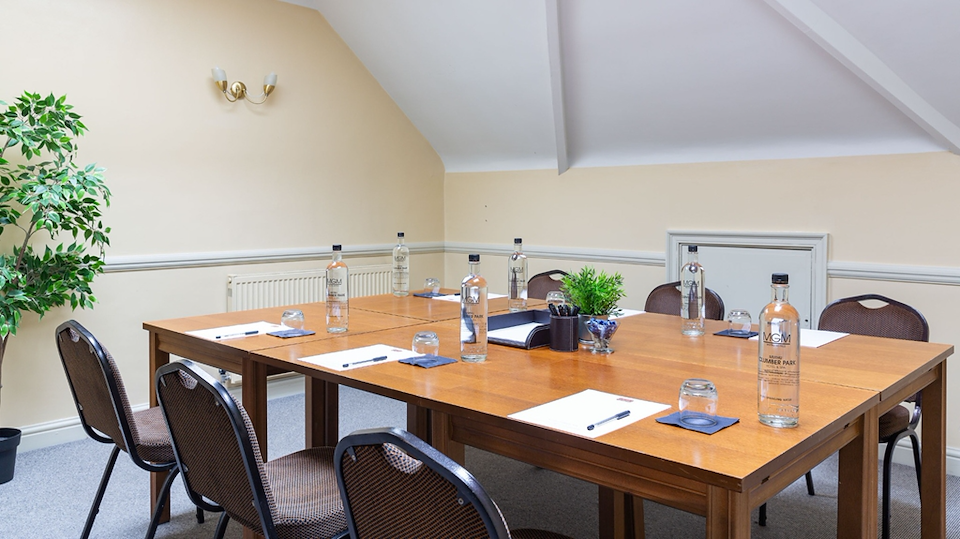 Boardroom setup at Clumber Park Hotel & Spa with angled ceiling for corporate meetings and events.