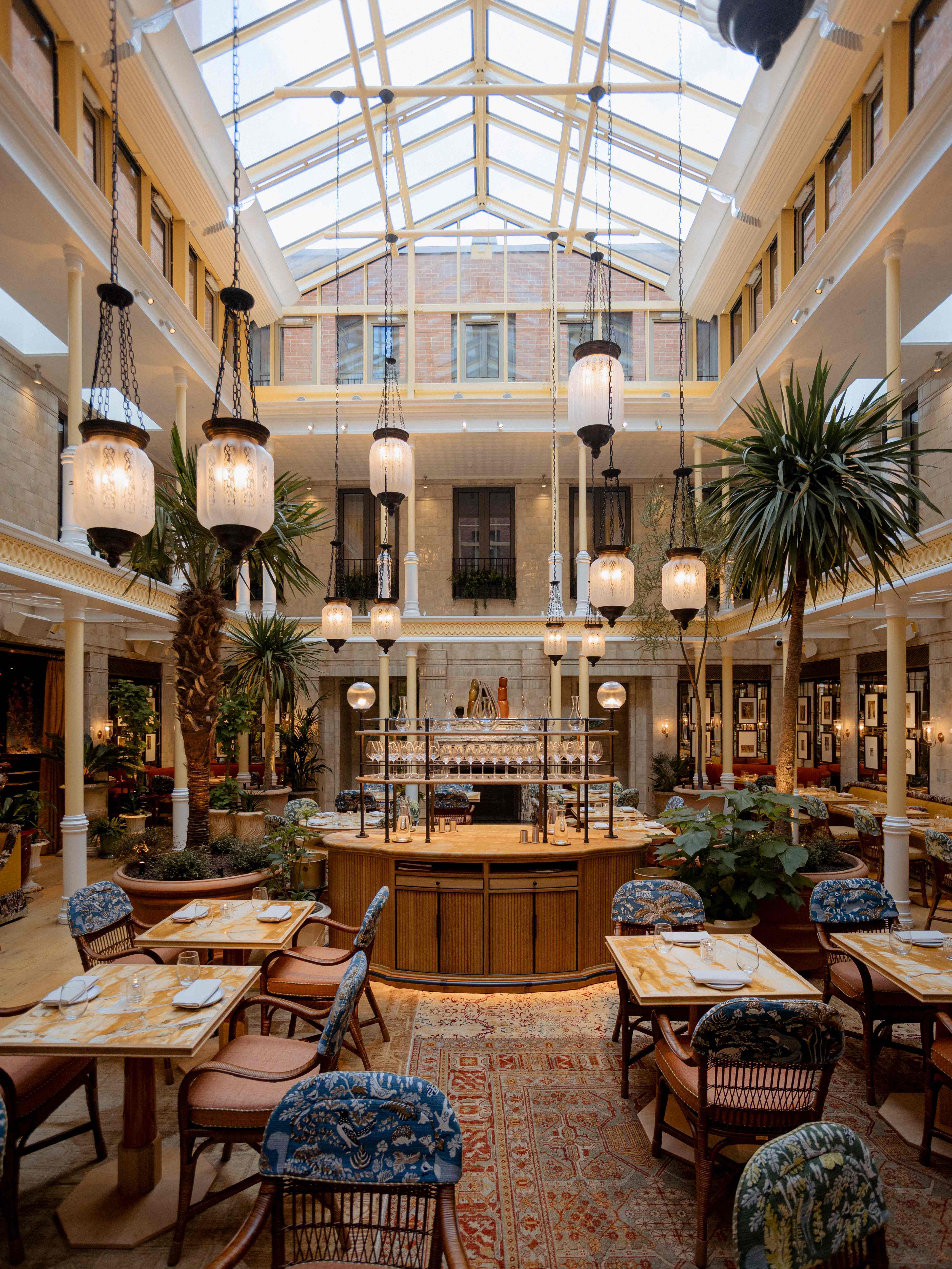 Elegant event space with vibrant atrium and greenery, ideal for networking or gatherings.