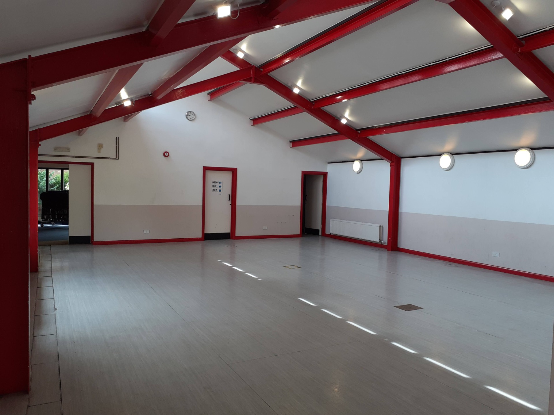 St Albans Church main hall, industrial red trusses, versatile event space, venue hire.