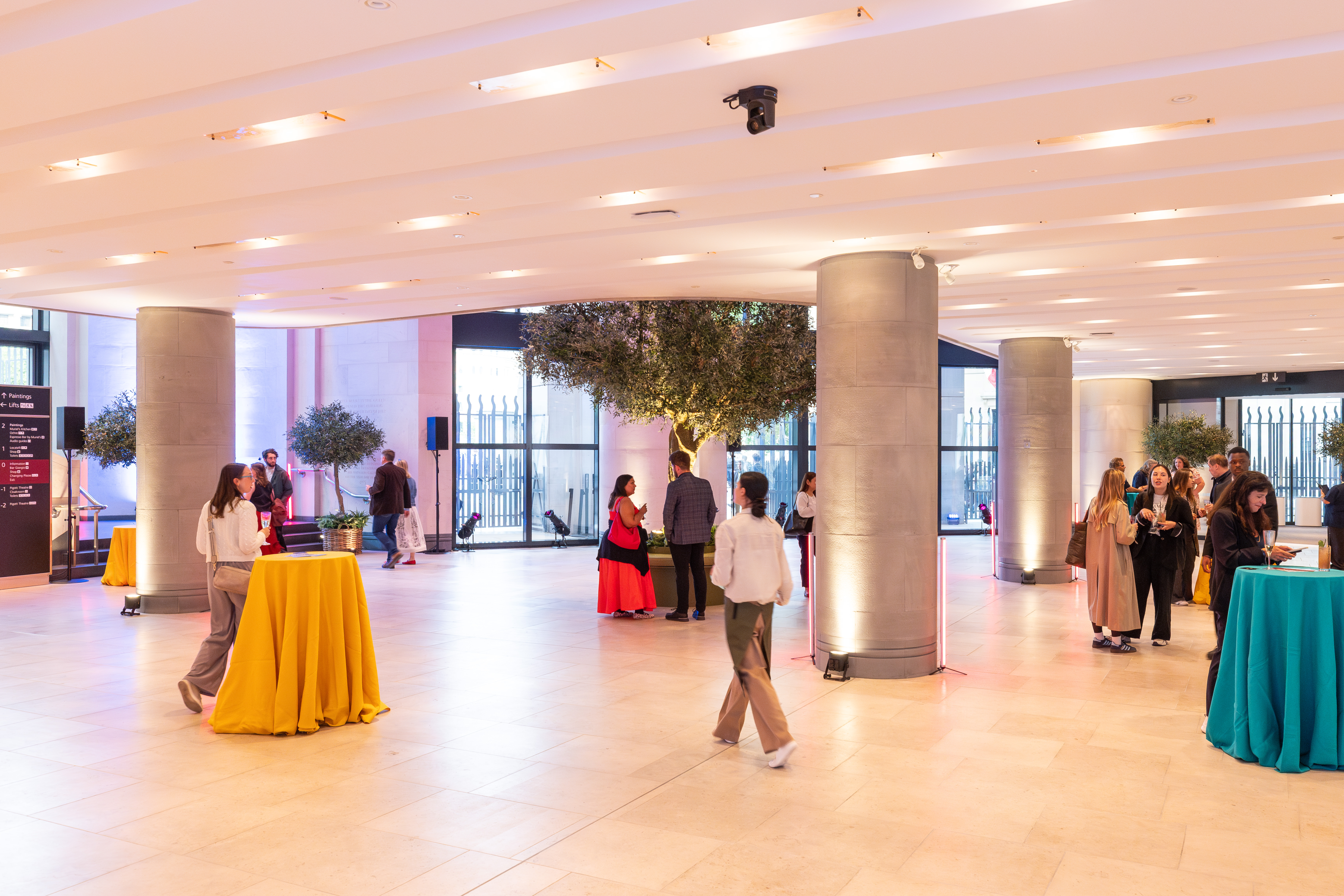 Sainsbury Wing Foyer event venue with colorful tables for networking and engagement.