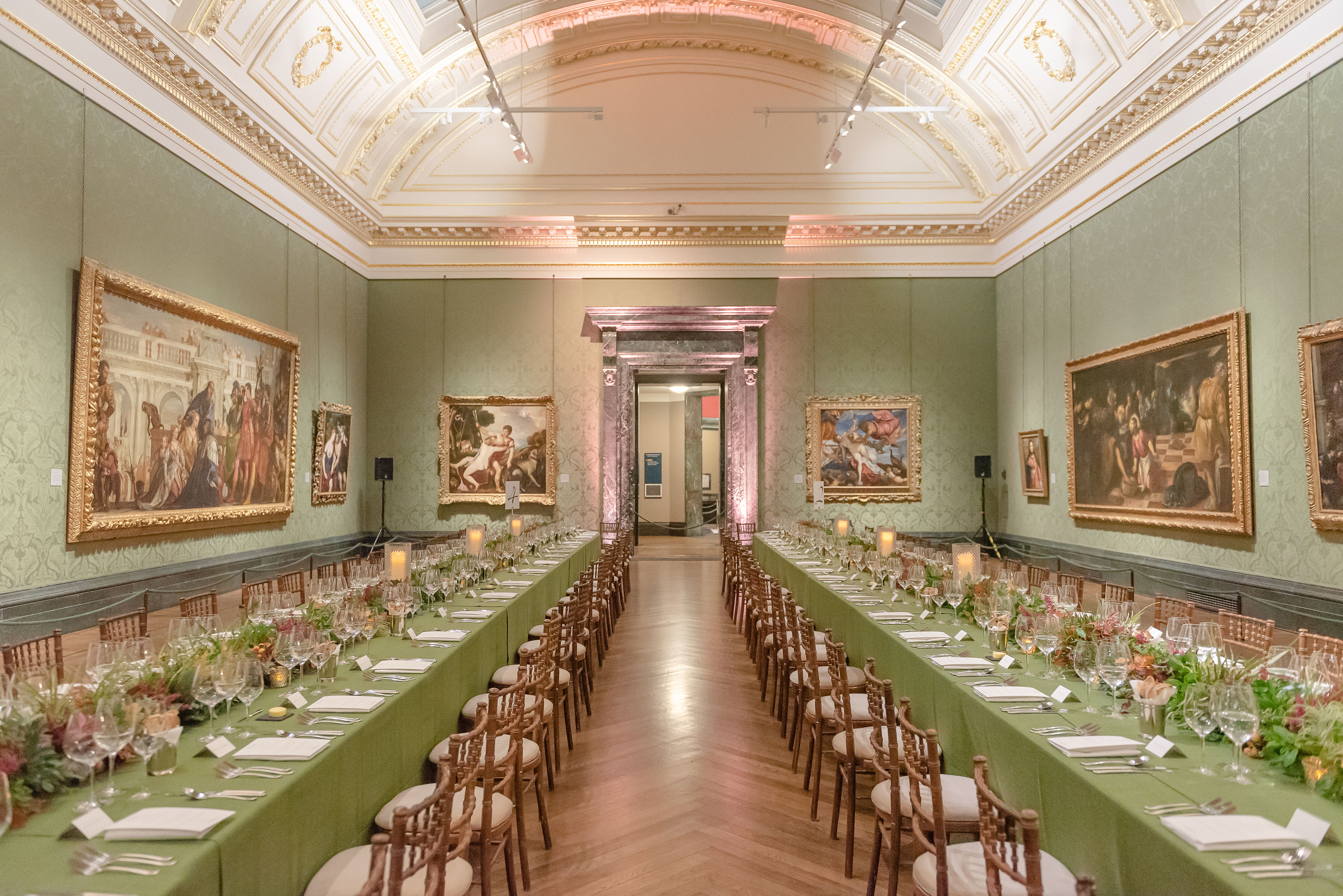 Elegant banquet hall at The Wohl Room, featuring green tables, ideal for galas and dinners.