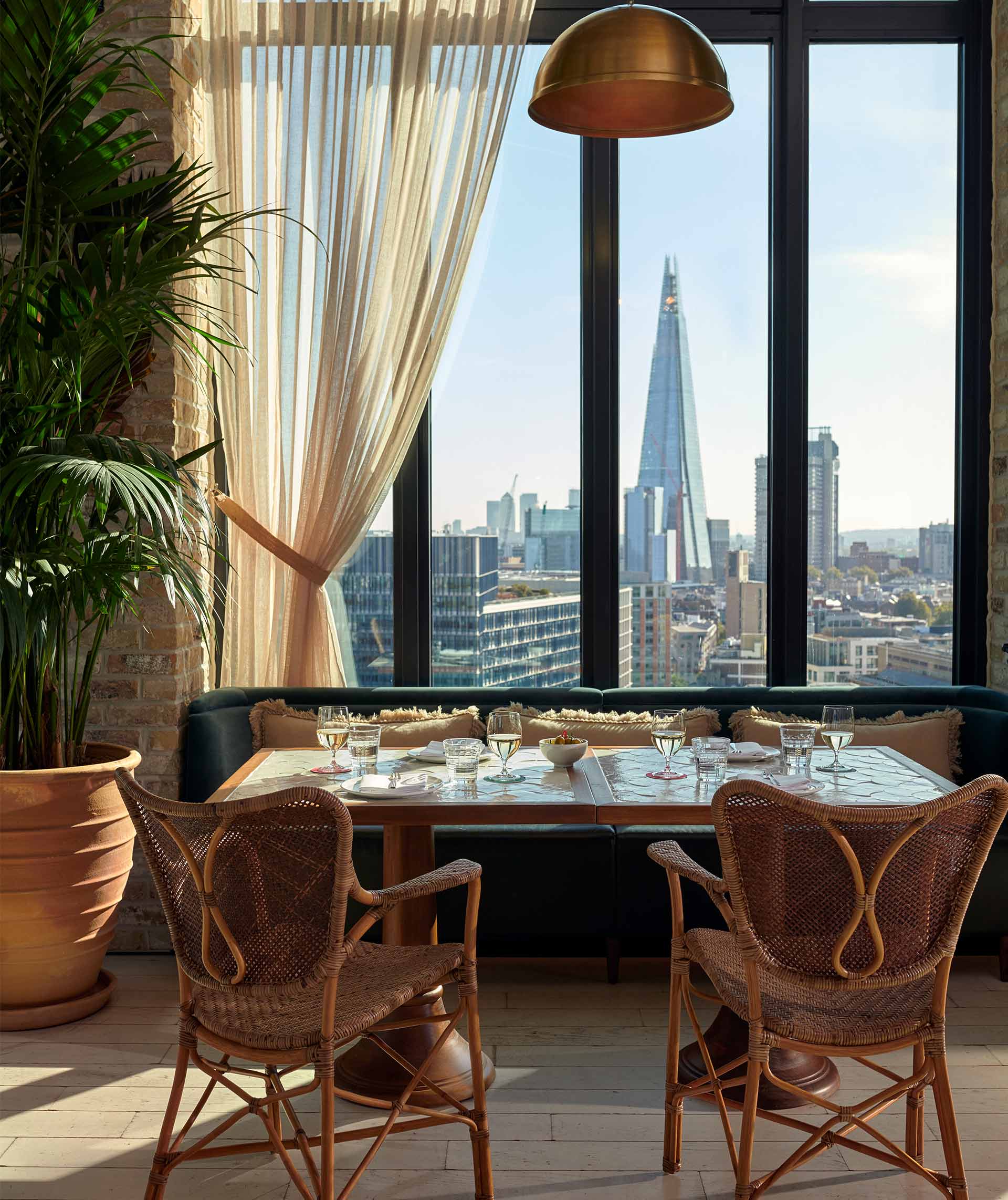 Sophisticated rooftop dining area with city skyline views, ideal for business events.