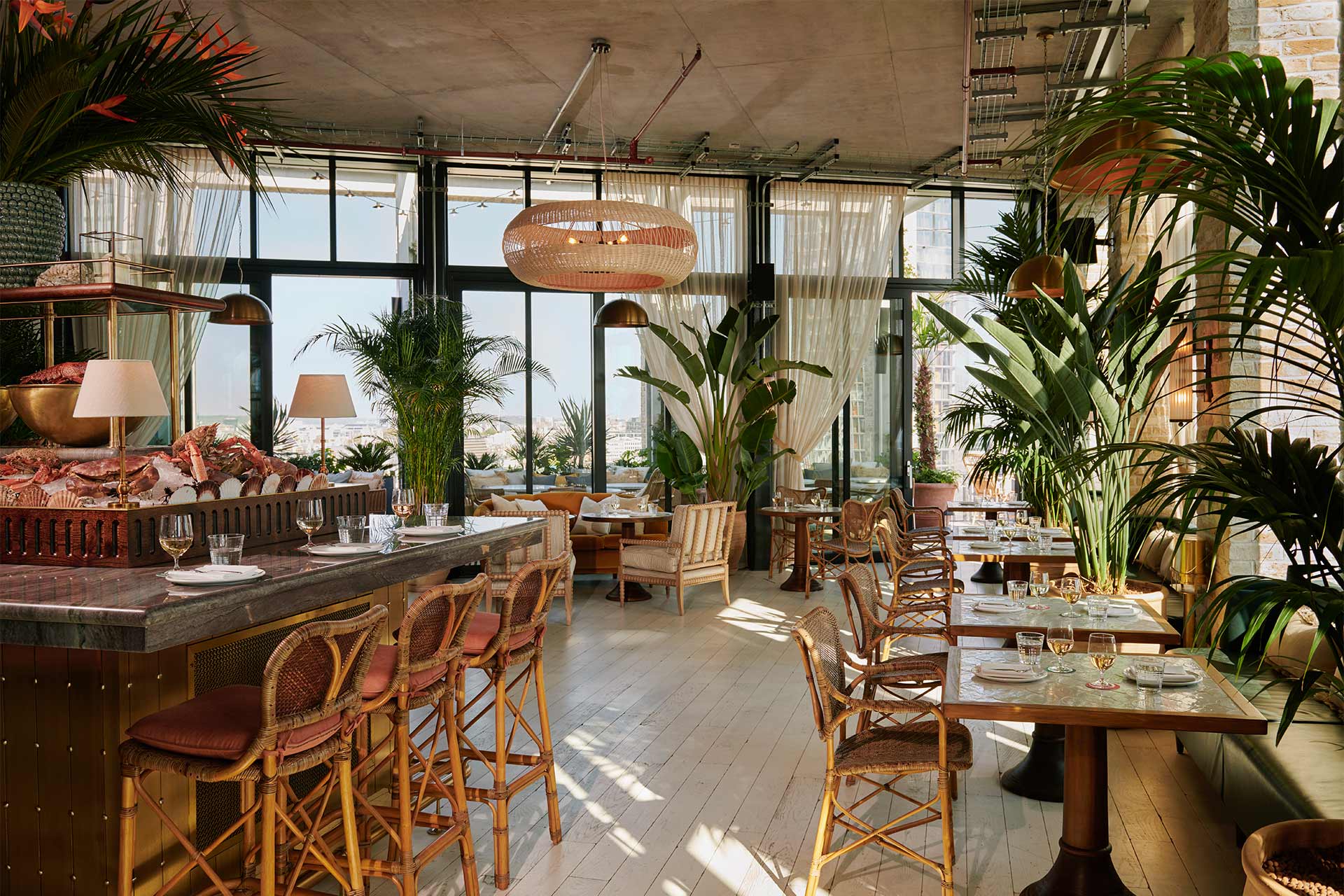 Elegant rooftop event space with large windows, perfect for networking and gatherings.