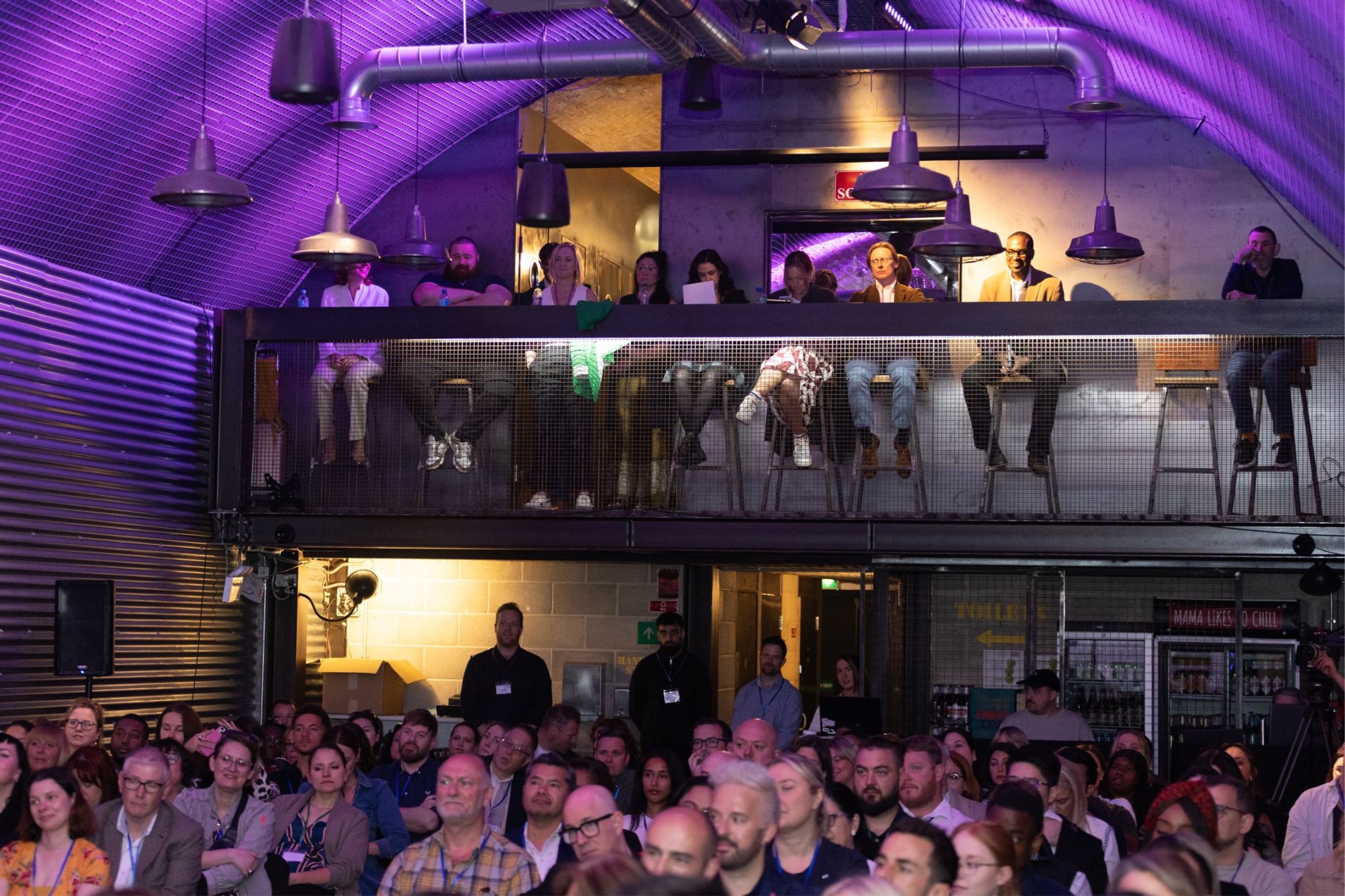 Dynamic event space at Mamuśka! with engaged audience and ambient lighting.