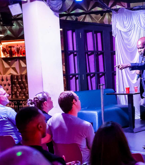 Keynote session at The MCR Lounge featuring dramatic lighting for corporate events and conferences.