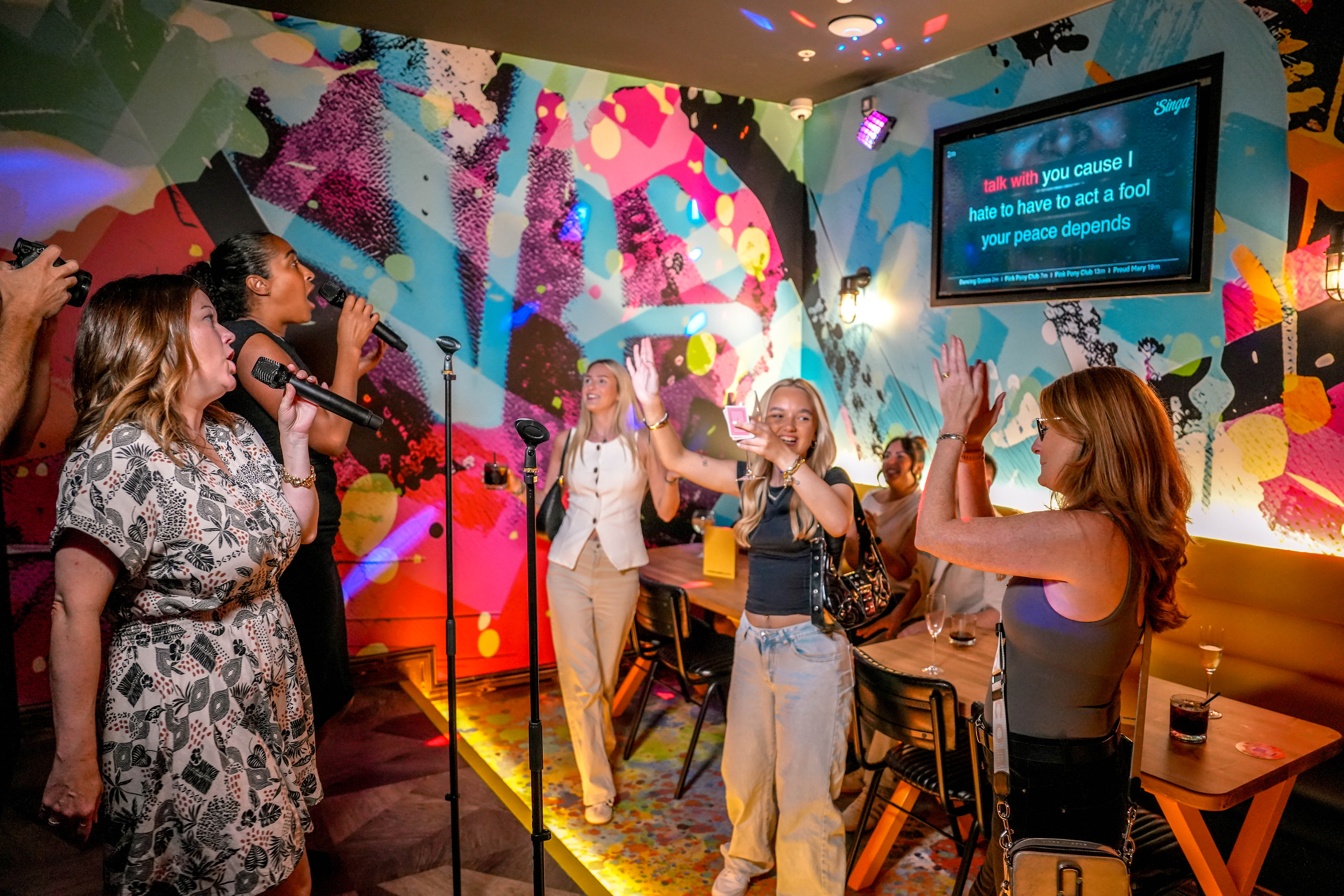 Vibrant karaoke room in Leeds for team-building events and corporate parties.