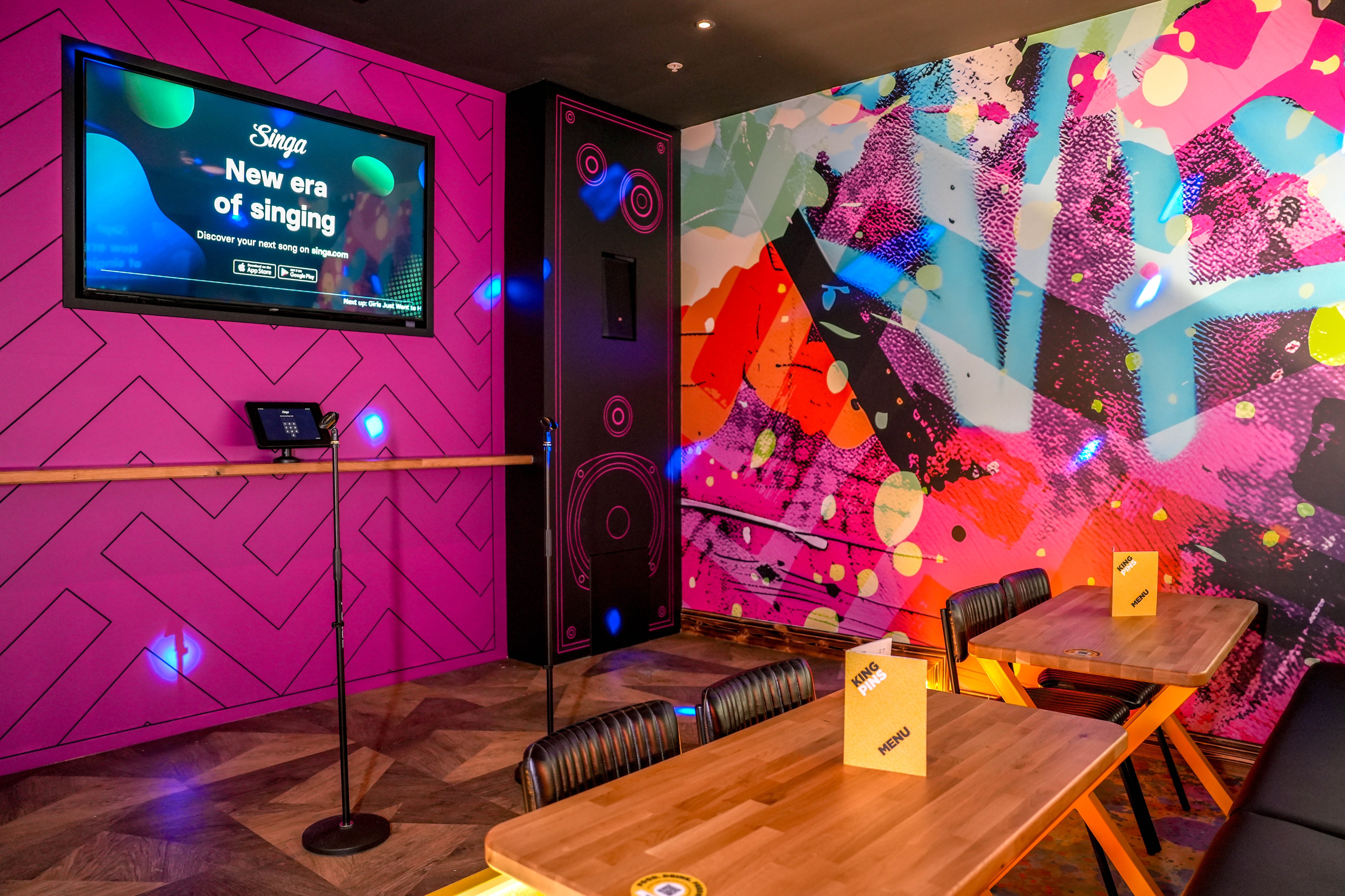 Vibrant karaoke room in King Pins Leeds, perfect for team-building and social events.