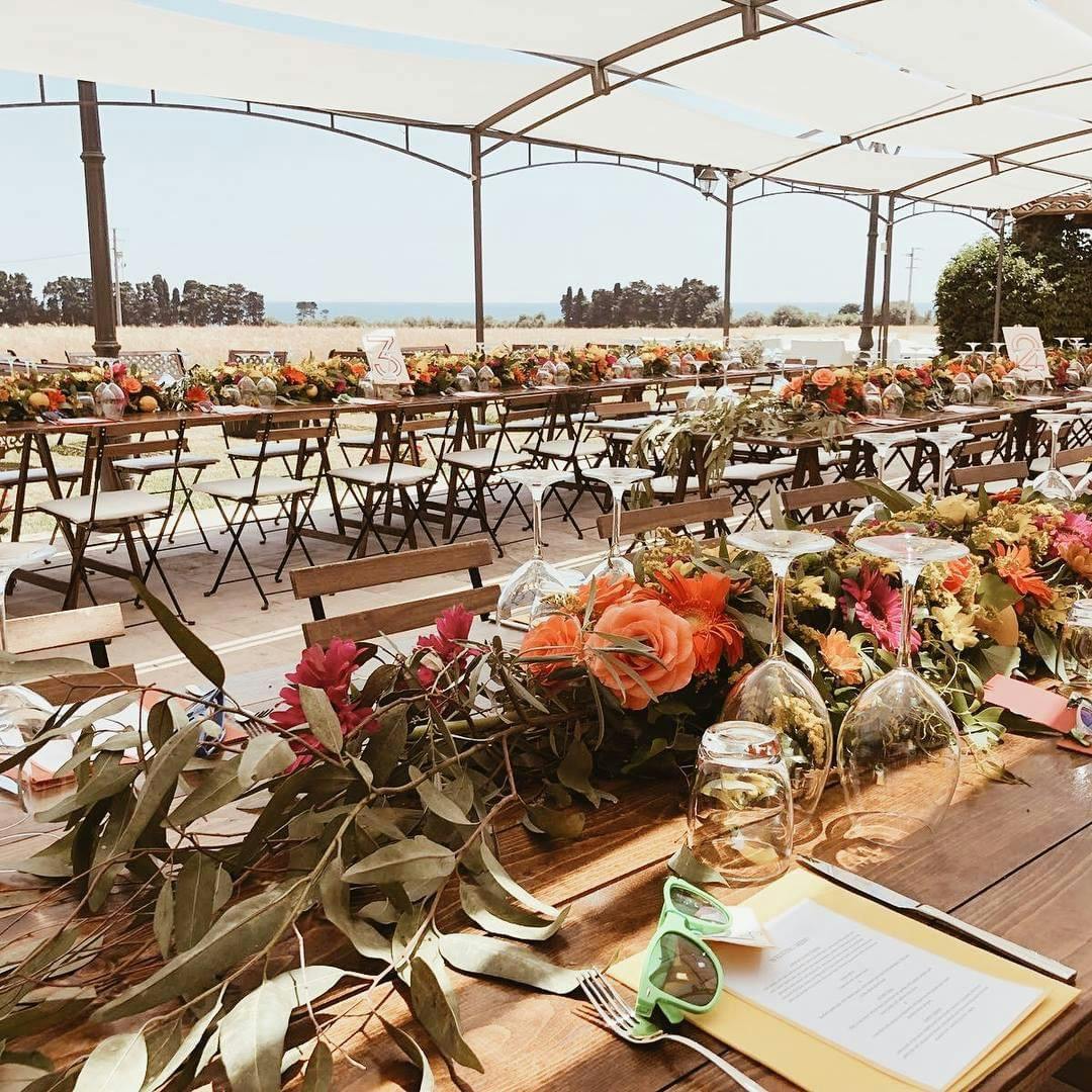 Alfresco outdoor event setup with floral runners for coastal luxury party planning.