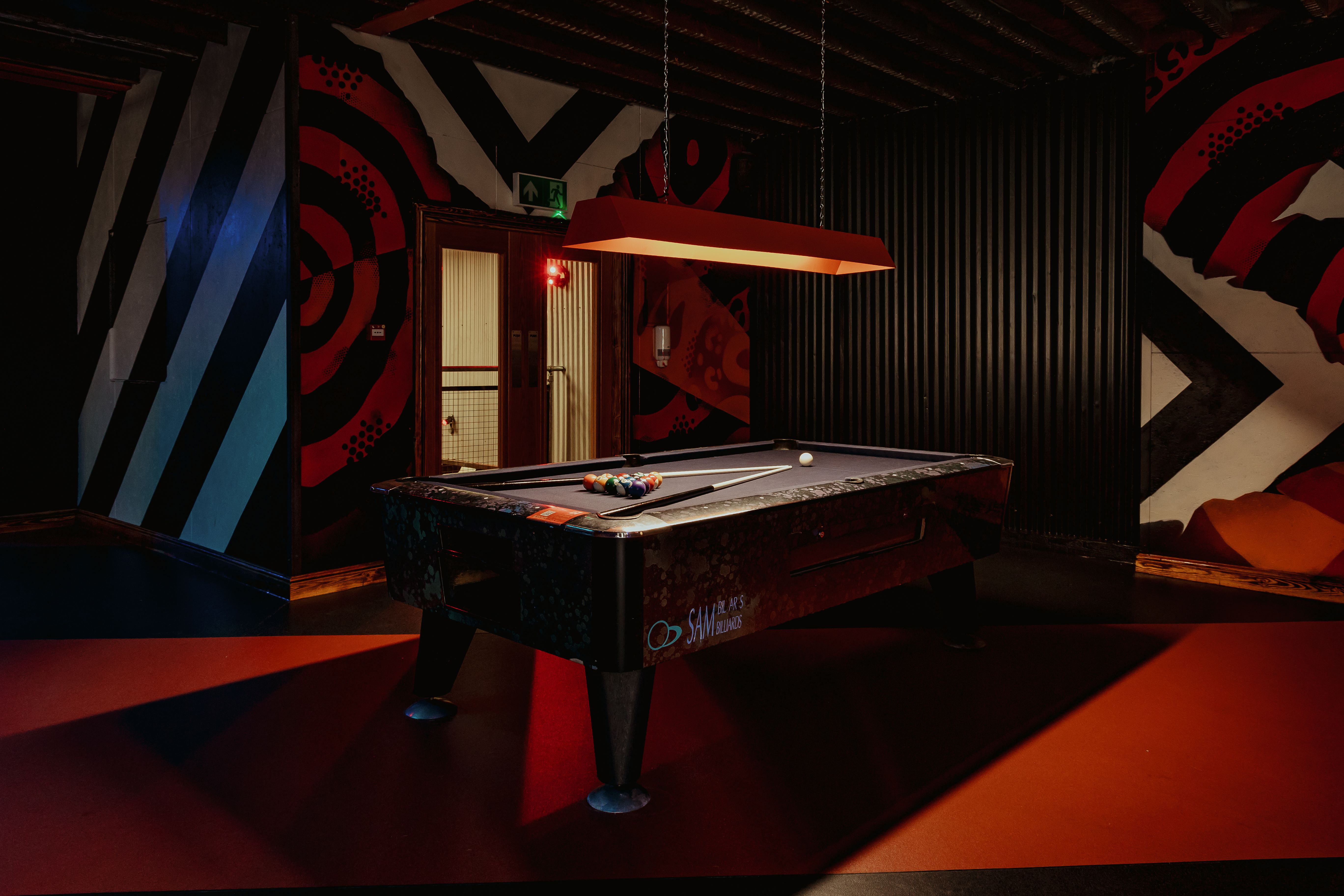 Vibrant game room with sleek pool table for networking events in Manchester.