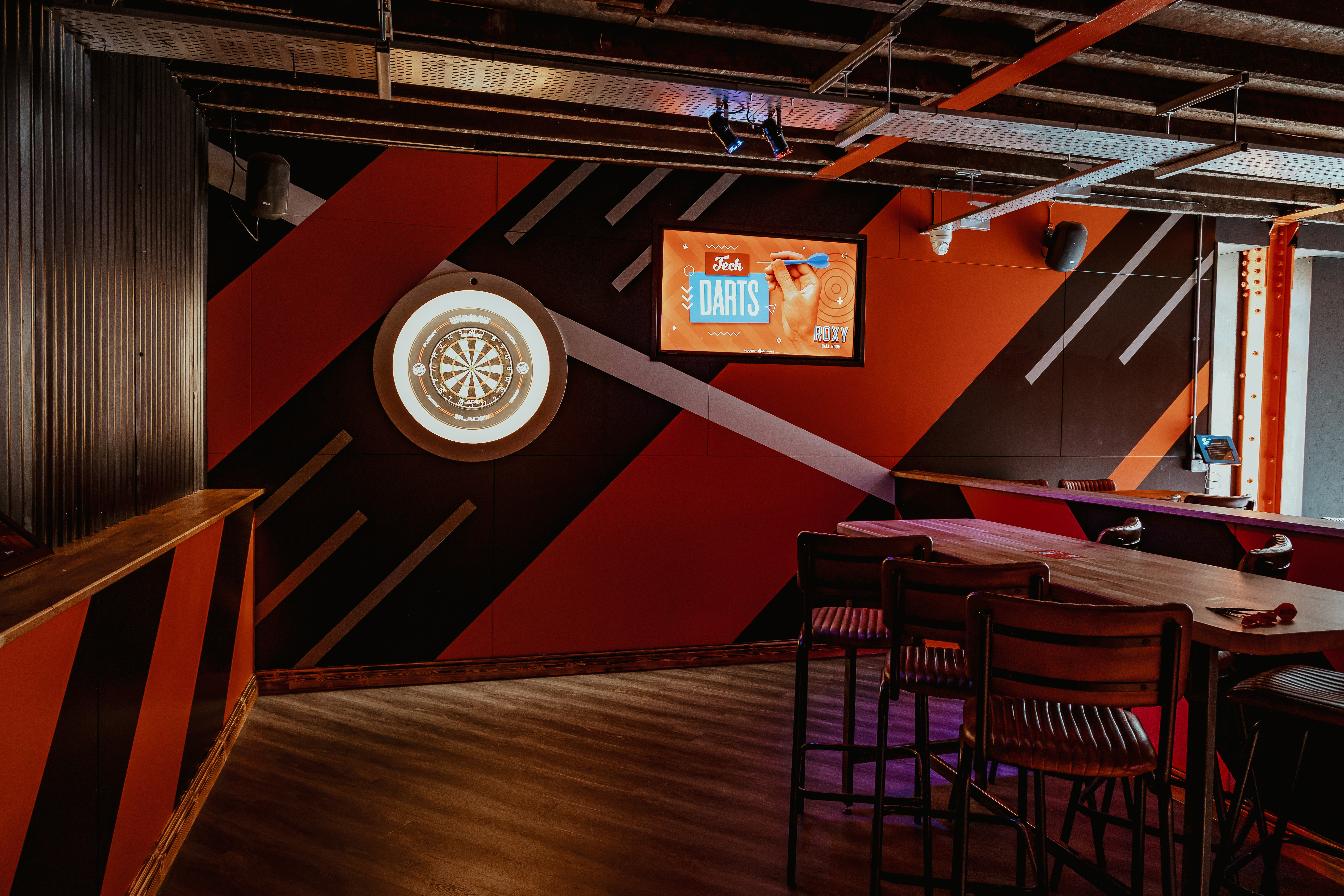 Alt tag: Vibrant event space at Roxy Ball Room, dartboard for team-building and social events.