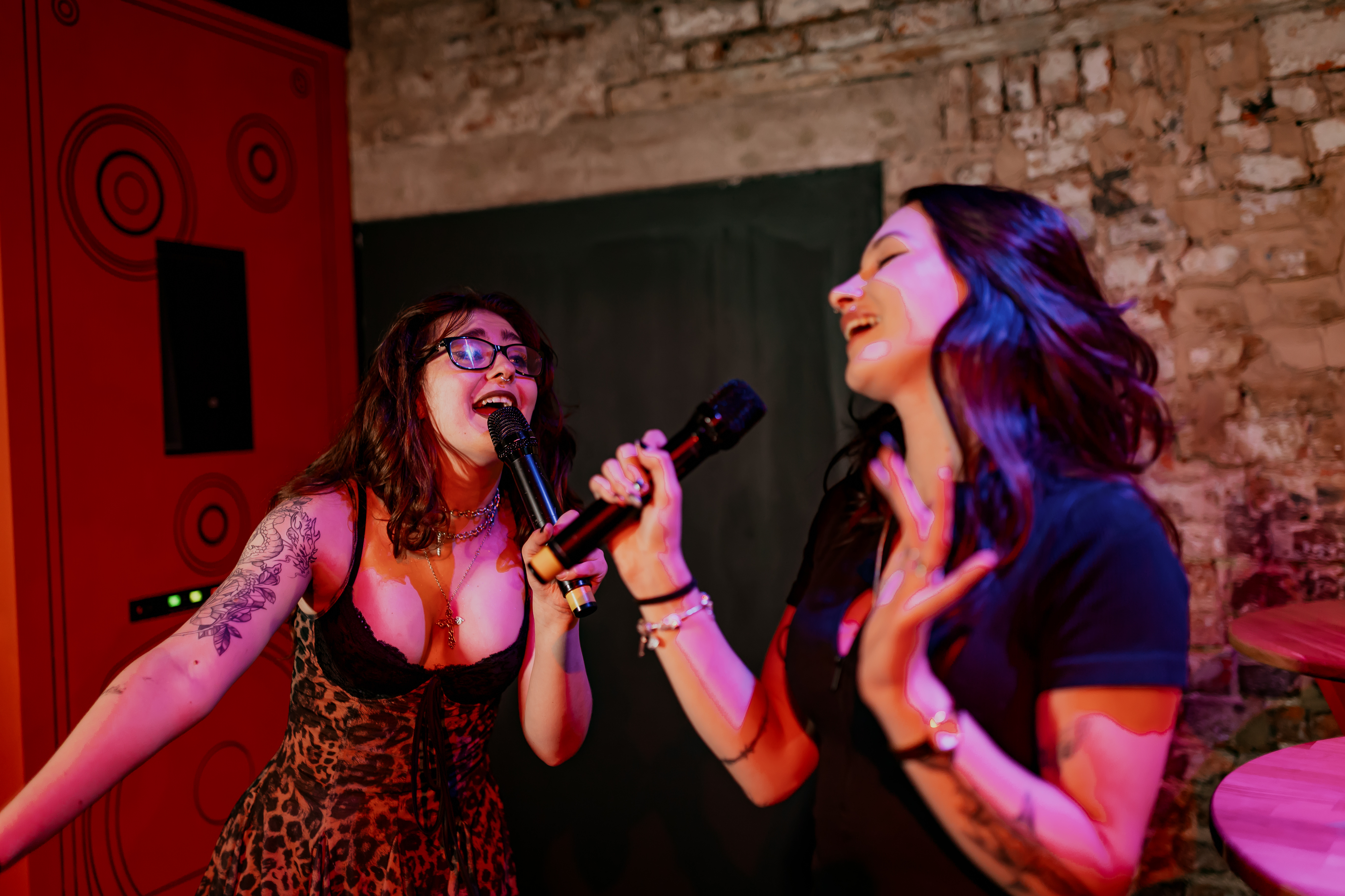 Karaoke room at Roxy Ball Room, Manchester, with engaging performers for team-building fun.
