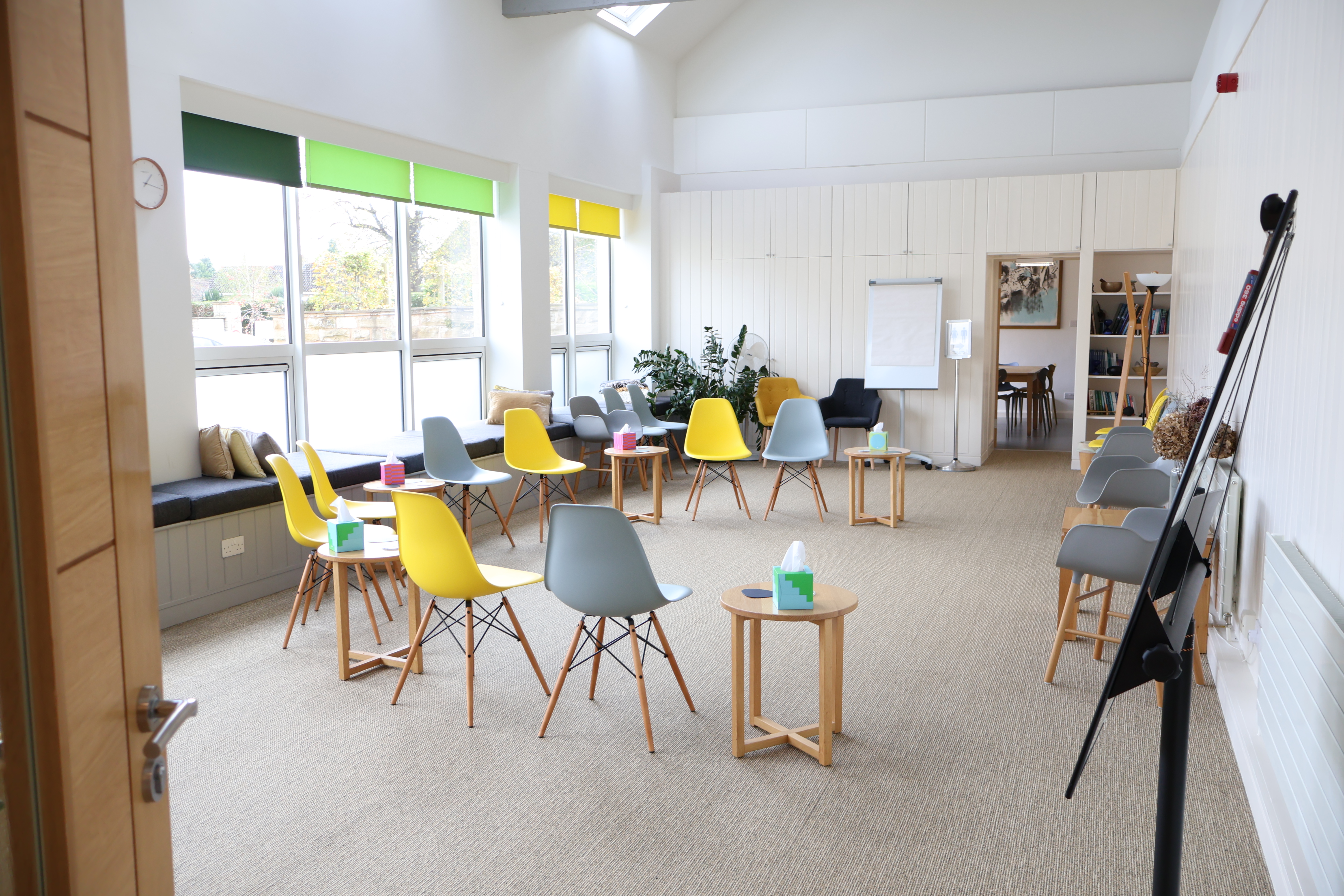 Brightly colored chairs in Oasis Studio, perfect for collaborative workshops and meetings.