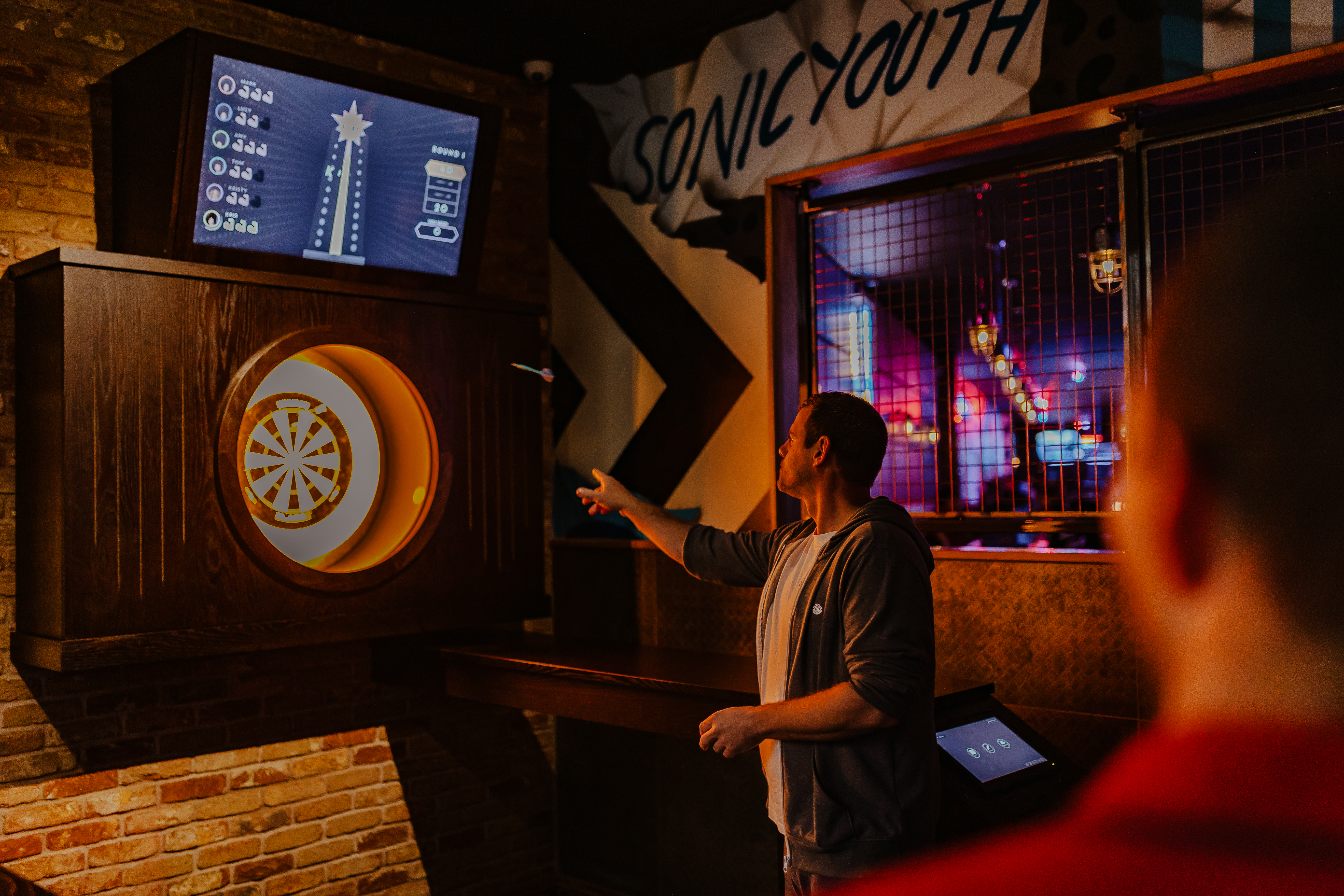 Dart game at Roxy Lanes, vibrant atmosphere for team-building and networking events.