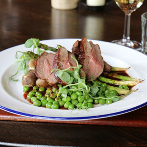 Expertly plated dish with tender meat and vibrant greens for elegant banquets and galas.
