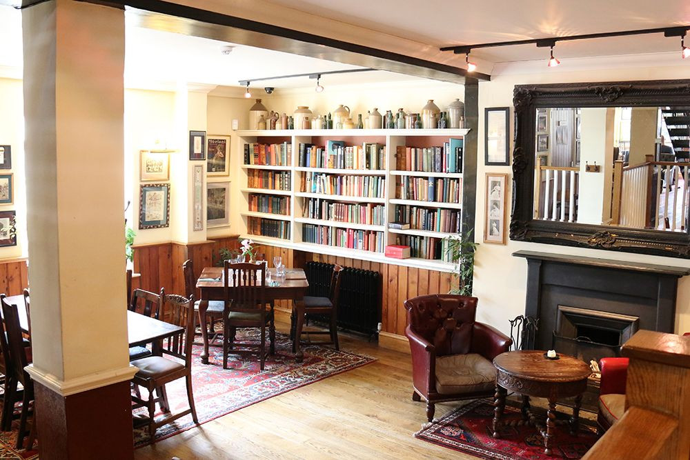Cozy library venue with wooden furniture, perfect for intimate gatherings and workshops.