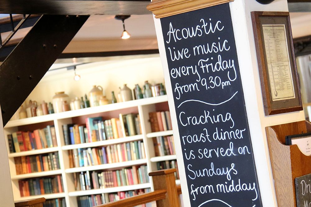 Cozy Library venue in The Wharf for intimate events, acoustic music, and Sunday roasts.
