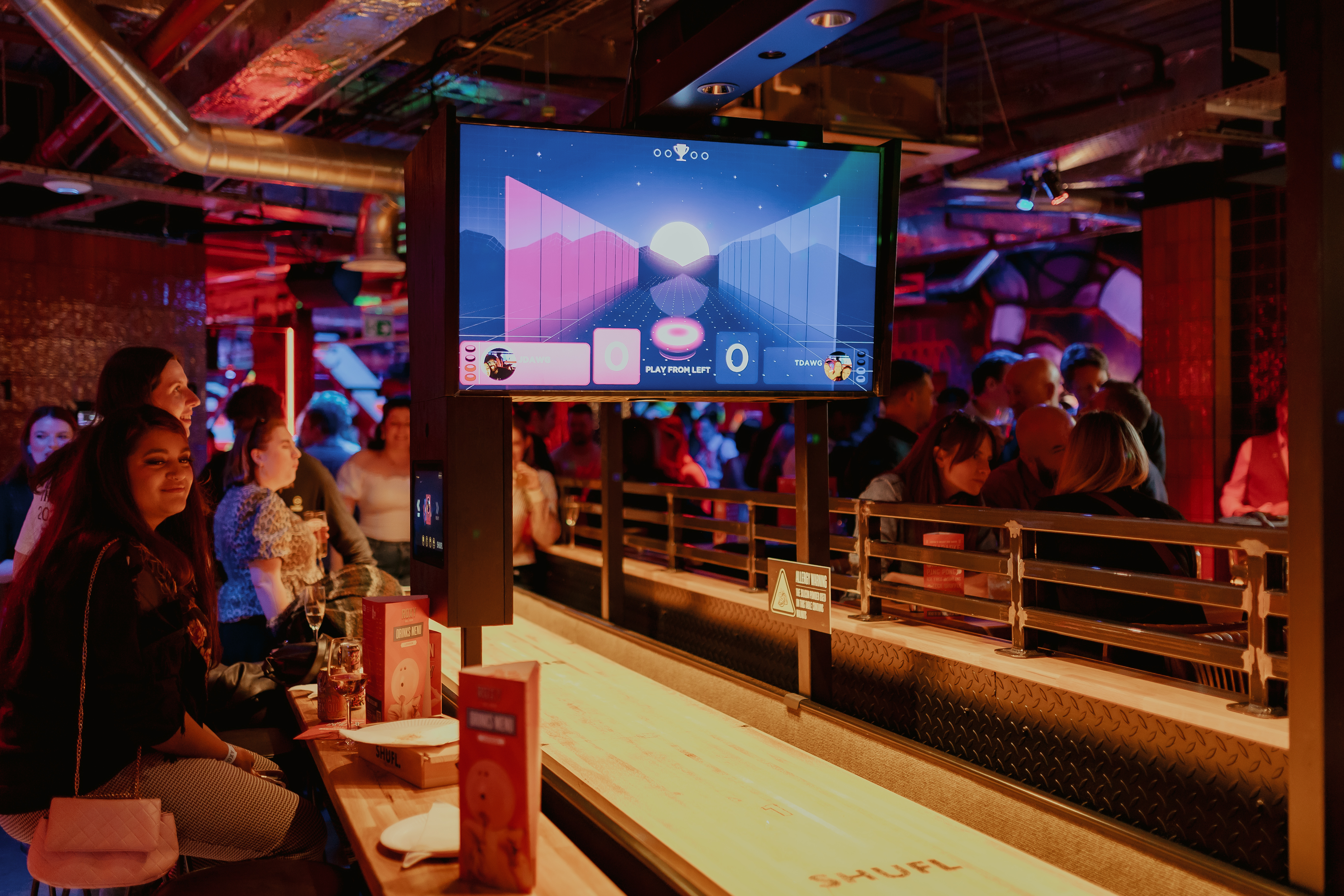 "Vibrant gaming hall event at Roxy Ball Room, London, with interactive activities."