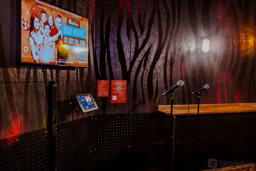 Karaoke and Beer Pong event at Roxy Ball Room London with vibrant decor and digital display.
