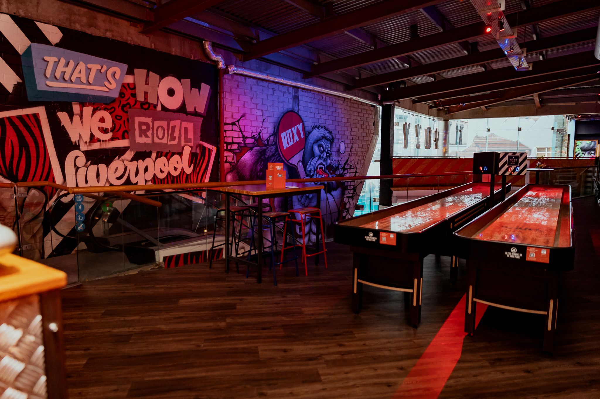 Shuffleboard area with colorful murals in Roxy Ball Room, Liverpool, perfect for networking events.