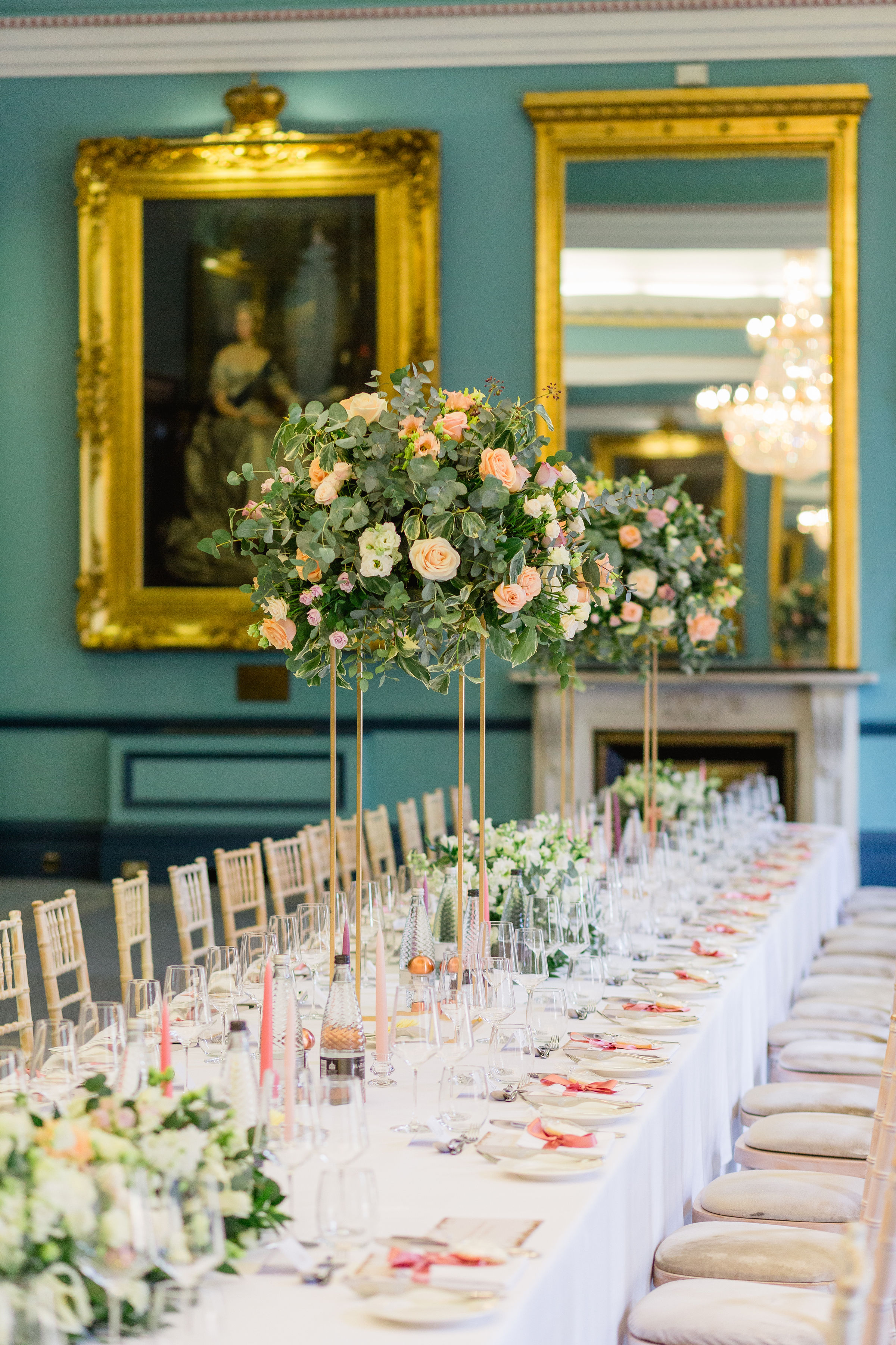 Elegant wedding venue at 116 Pall Mall with tall floral centerpieces and opulent decor.