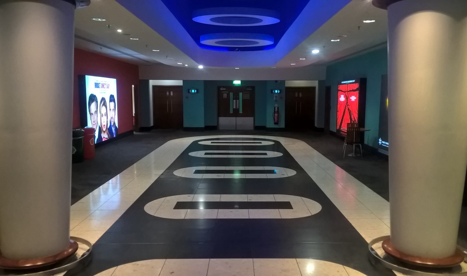 Cinema screens in Vue Leeds corridor, spacious design for networking events.