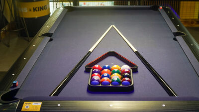 Pool table with billiard balls at King Pins Trafford Palazzo for corporate events.